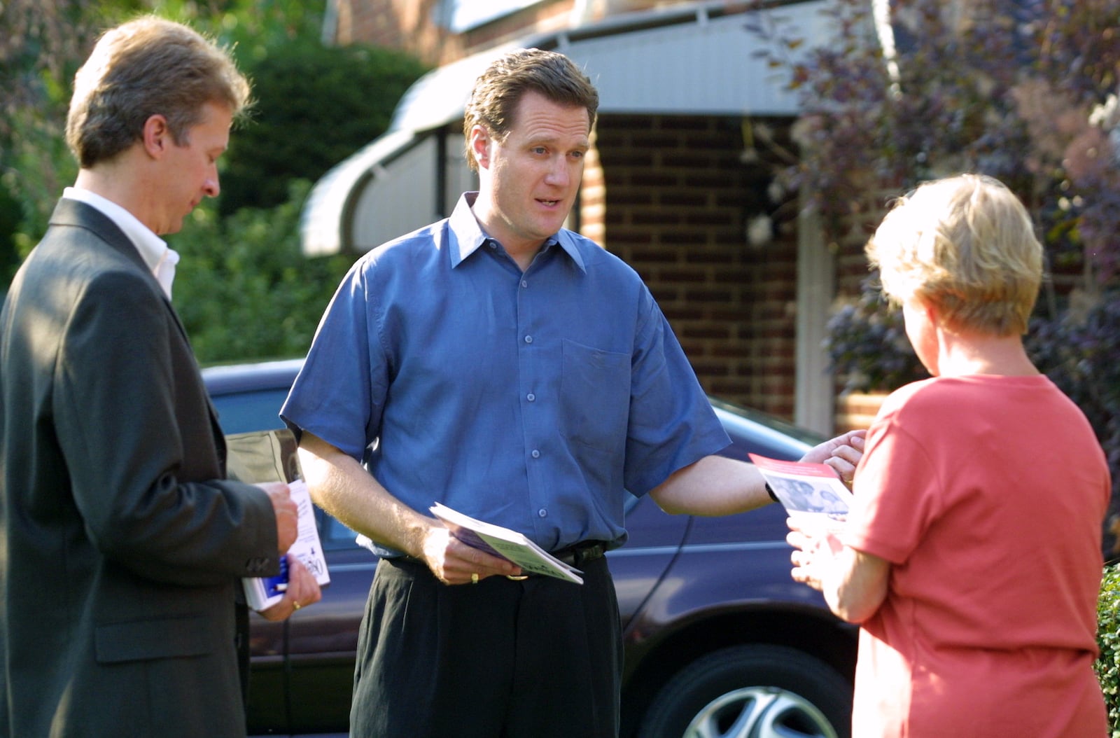 Mike Osgood (left) who is campaigning for a Dayton City Commission seat and Mayor Mike Turner (center), who is campaigning for mayor, hit the streets talking to voters like Peyton Ballard (right).