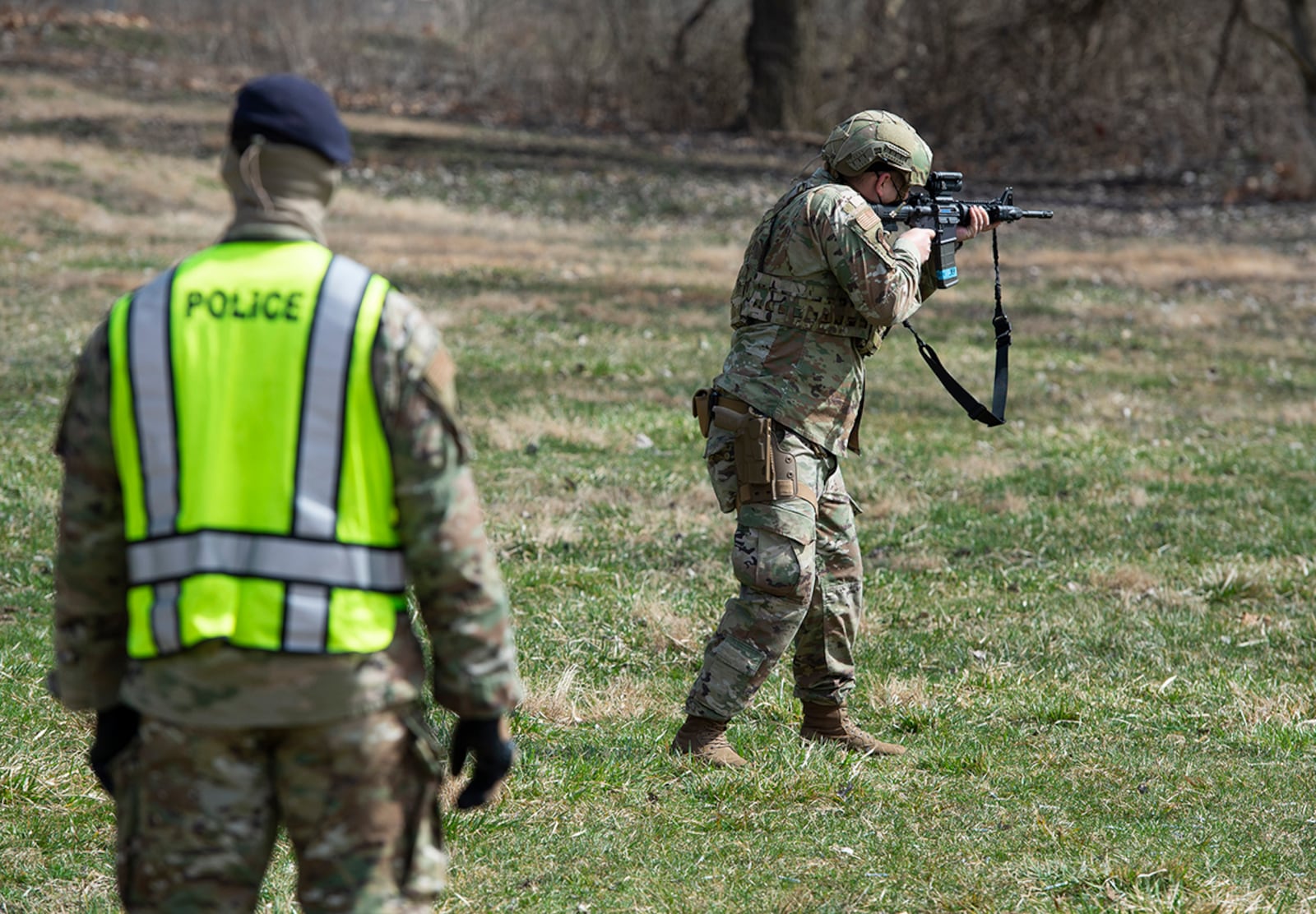 A member of the 88th Security Forces Squadron fires a Simunition round at a fixed target with an M4 carbine rifle as Staff Sgt. Sherman Gramby, a unit training instructor, observes during sustainment training March 17 at Wright-Patterson Air Force Base. U.S. AIR FORCE PHOTO/WESLEY FARNSWORTH