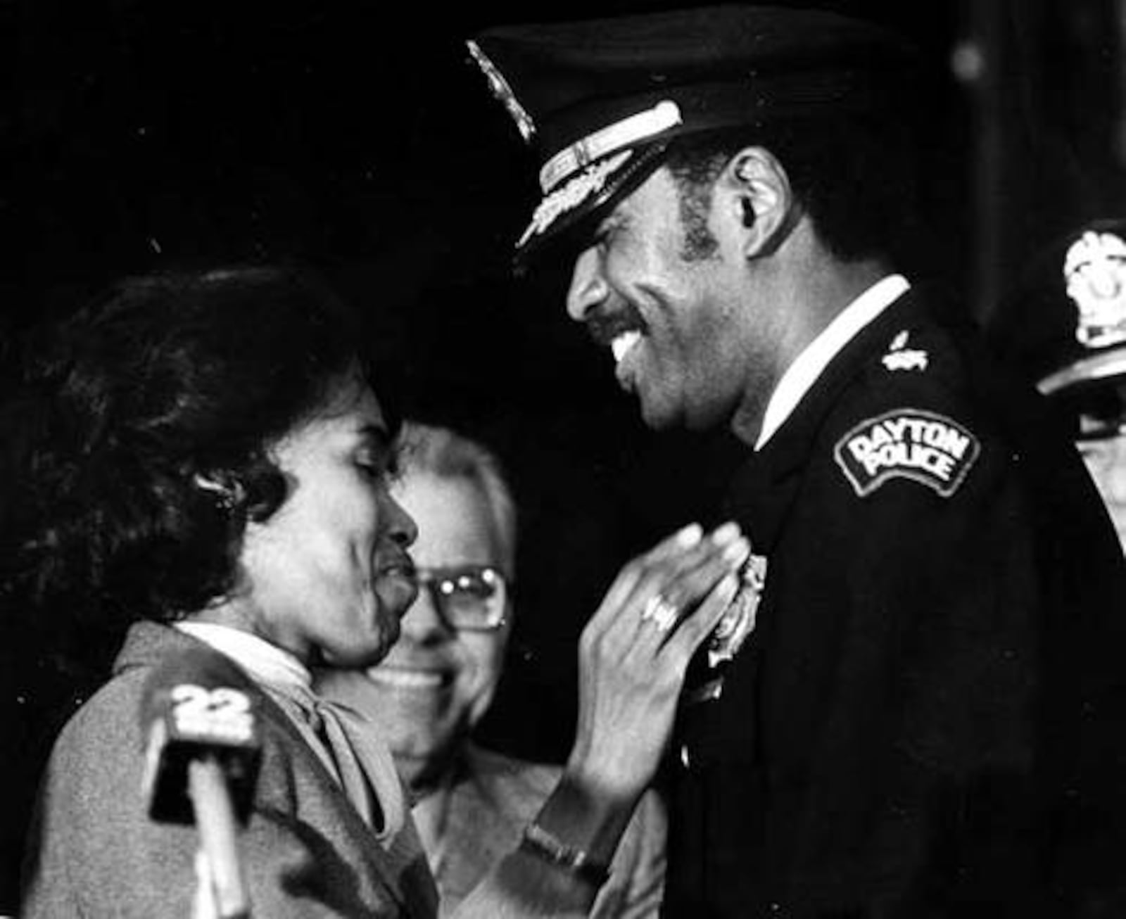 New Police Chief Tyree Broomfield gets his new badge pinned on by his wife after swearing in ceremonies at the Arcade Square, 1983.