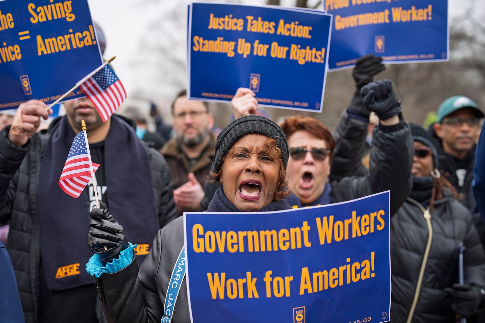 Sona Anderson of San Diego, center, shouts her support for civil service workers as activists protest the policies of President Donald Trump and Elon Musk outside the Capitol in Washington, Tuesday, Feb. 11, 2025. (AP Photo/J. Scott Applewhite)