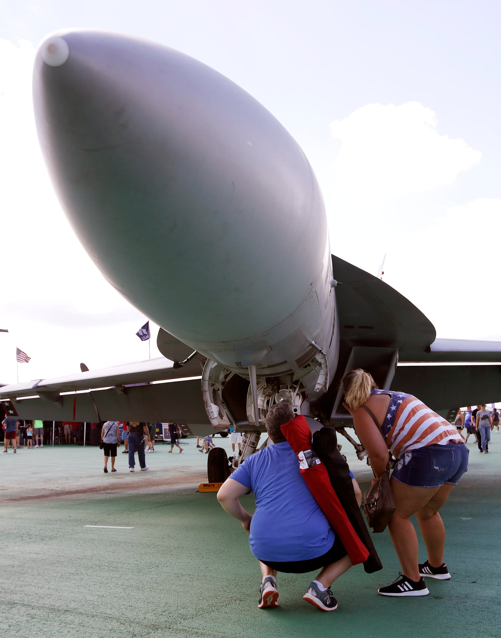 Katie Miller and Doug Easton from Troy checked out the details of the Navy F/A-18 Hornet on Sunday at the Vectren Dayton Air Show.   TY GREENLEES / STAFF