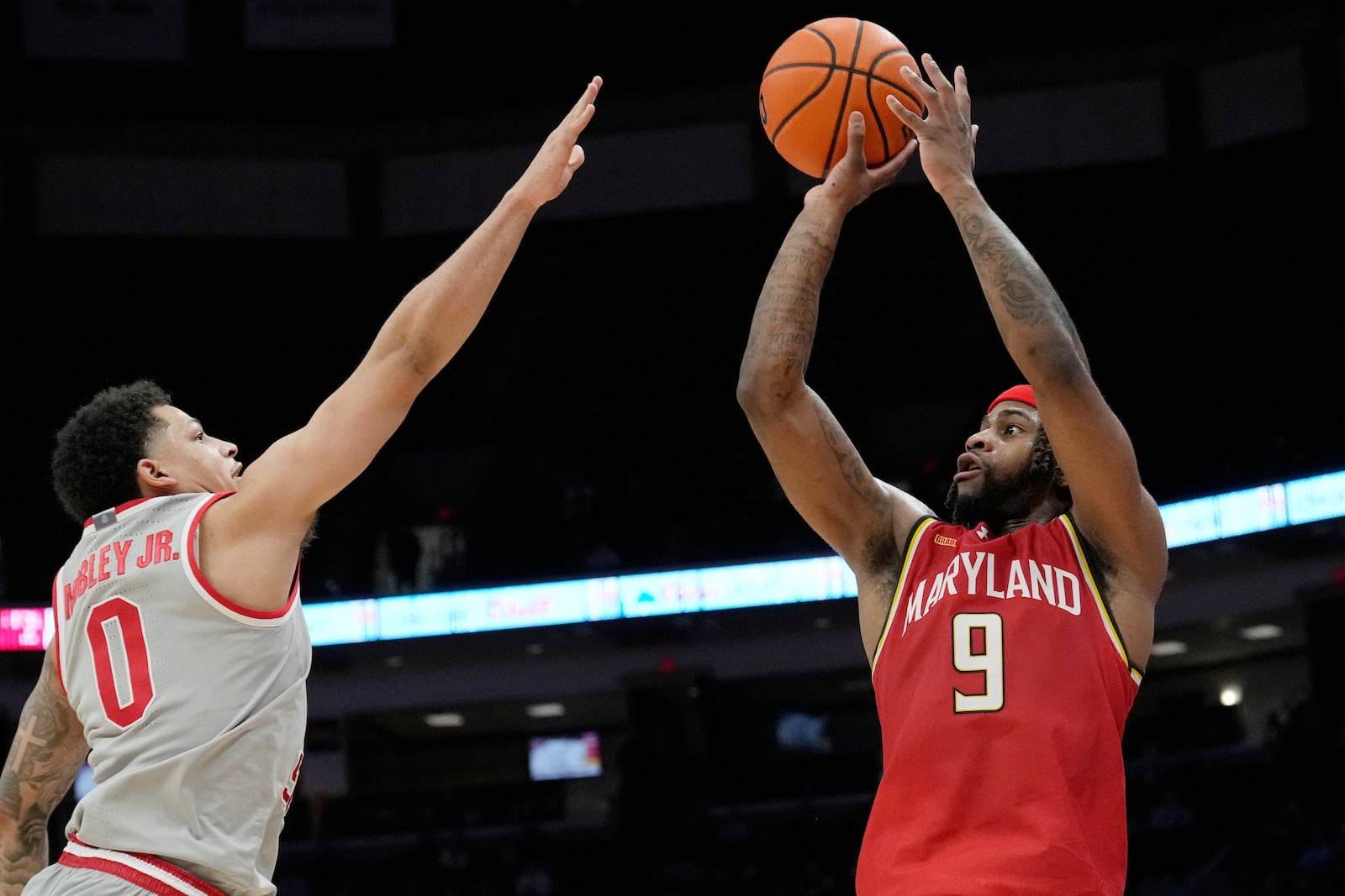 Maryland guard Selton Miguel (9) looks to shoot as Ohio State guard John Mobley Jr. (0) defends in the first half of an NCAA college basketball game Thursday, Feb. 6, 2025, in Columbus, Ohio. (AP Photo/Sue Ogrocki)