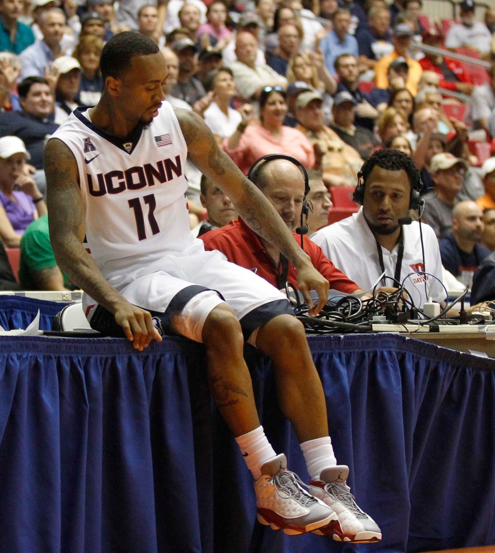 Connecticut guard Ryan Boatright lands on press row right in front of WHIO's Larry Hansgen and Brooks Hall during a game against Dayton in the semifinals of the Puerto Rico Tip-Off on Friday, Nov. 21, 2014, at Coliseo Roberto Clemente in San Juan, P.R.