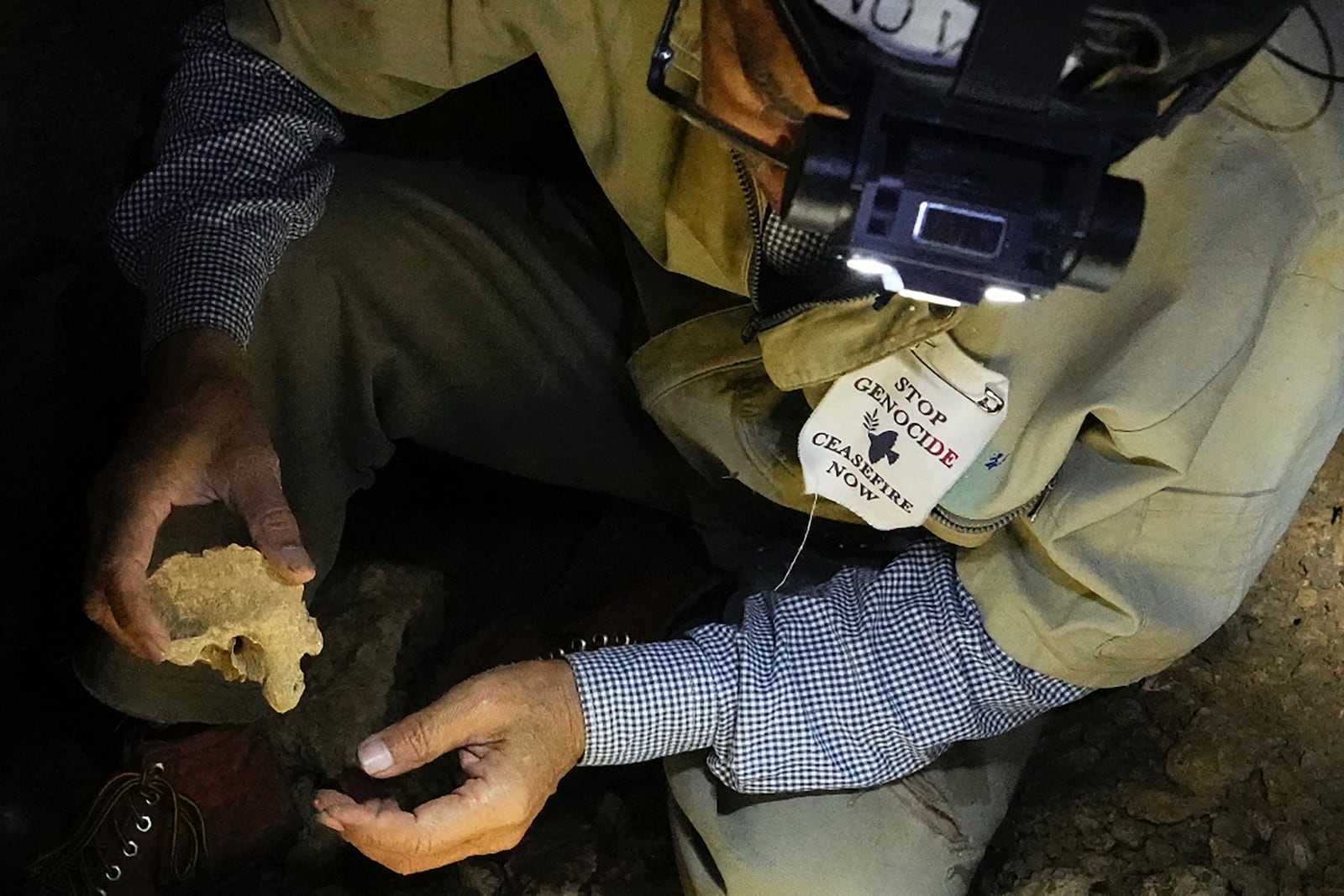 Takamatsu Gushiken shows a piece of human bones he found in the past, the remains of those who died during the Battle of Okinawa towards the end of the World War II in 1945, while in a cave in Itoman, on the main island of the Okinawa archipelago, southern Japan, Saturday, Feb. 15, 2025. (AP Photo/Hiro Komae)