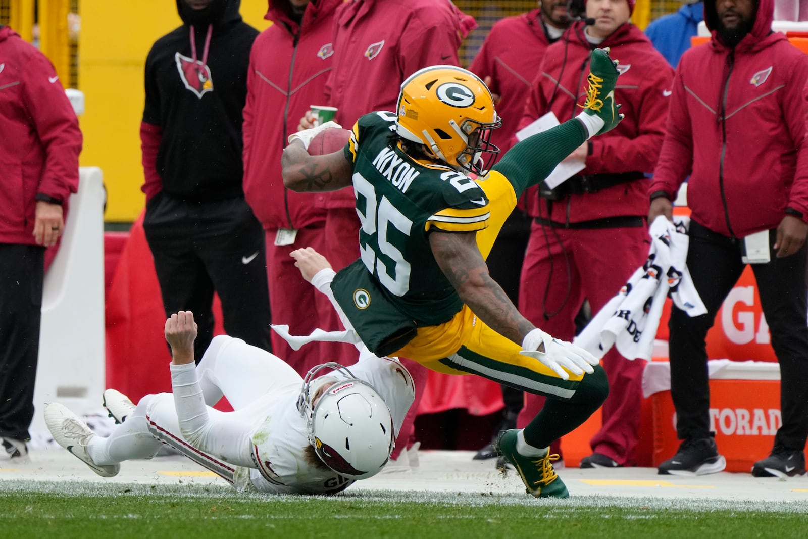 Arizona Cardinals punter Blake Gillikin stops Green Bay Packers cornerback Keisean Nixon (25) on a punt return during the first half of an NFL football game, Sunday, Oct. 13, 2024, in Green Bay. (AP Photo/Morry Gash)