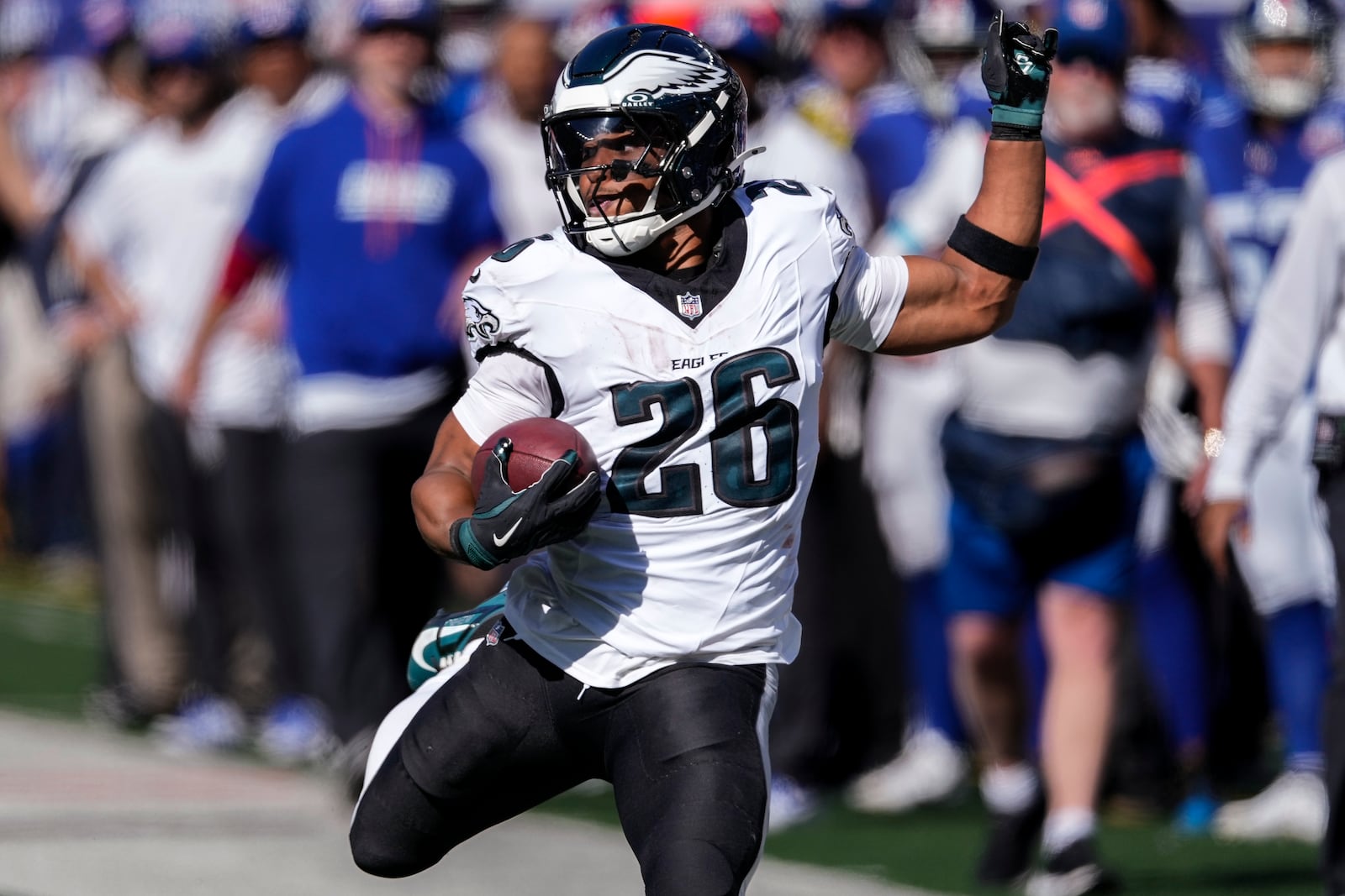 Philadelphia Eagles running back Saquon Barkley (26) carrie the ball for a first down against the New York Giants during the second quarter of an NFL football game, Sunday, Oct. 20, 2024, in East Rutherford, N.J. (AP Photo/Seth Wenig)