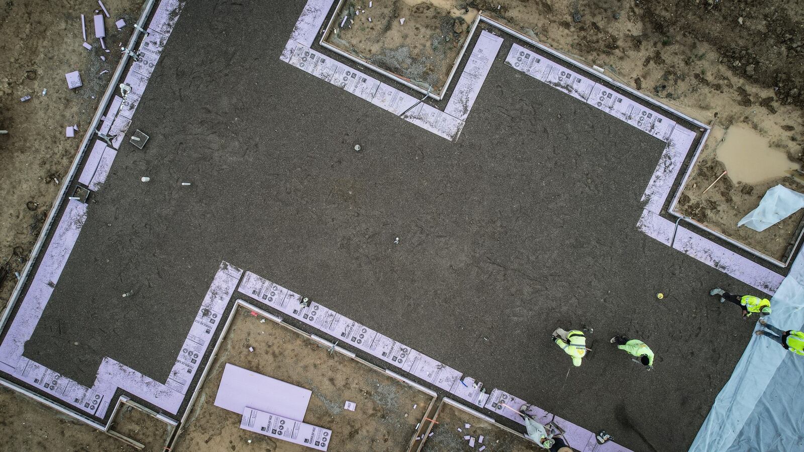 Concrete workers pour a foundation for Redwood Apartment Neighborhoods at Chamberlin Crossing in Miamisburg Wednesday, April 10, 2024. Total new permits pulled for 2023 numbered 1,697 for 2023, down 14.8% from 2022, according to Home Builders Association of Dayton. JIM NOELKER/STAFF