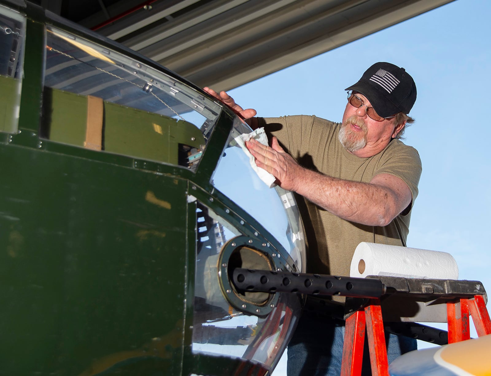 Dale Davis, a Champaign Aviation Museum volunteer, cleans the nose window of the World War II-era B-25 bomber Champaign Gal on April 23 in Urbana. The Champaign Gal is one of the few B-25s still airworthy and flying. U.S. AIR FORCE PHOTO/R.J. ORIEZ