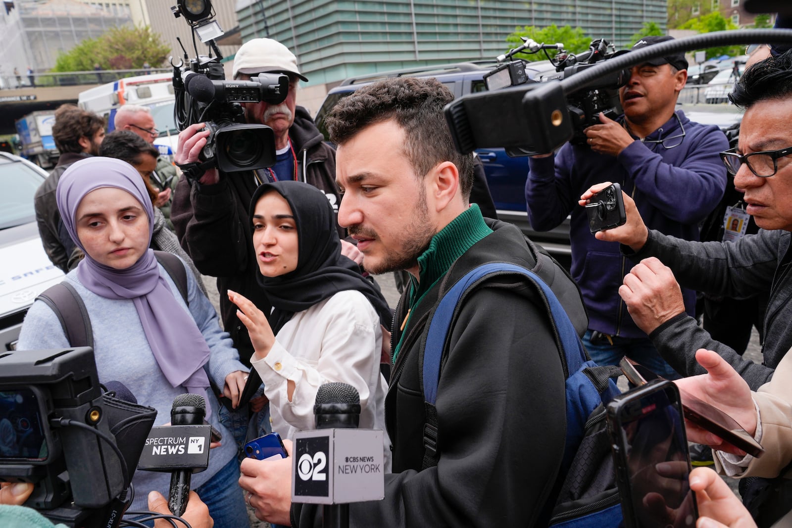 FILE - Members of the Columbia University Apartheid Divest group, including Sueda Polat, second from left, and Mahmoud Khalil, center, are surrounded by members of the media outside the Columbia University campus, Tuesday, April 30, 2024, in New York. (AP Photo/Mary Altaffer, File)