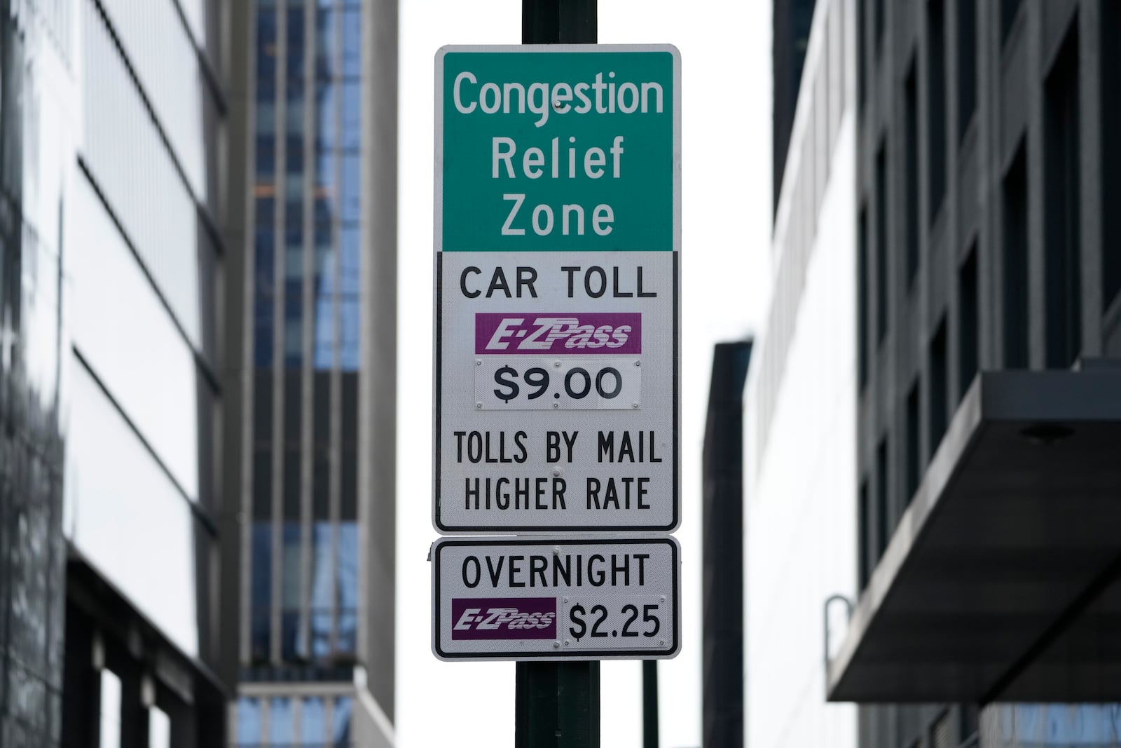 Signs advising drivers of congestion pricing tolls are displayed near the exit of the Lincoln Tunnel in New York, Wednesday, Feb. 19, 2025. (AP Photo/Seth Wenig)