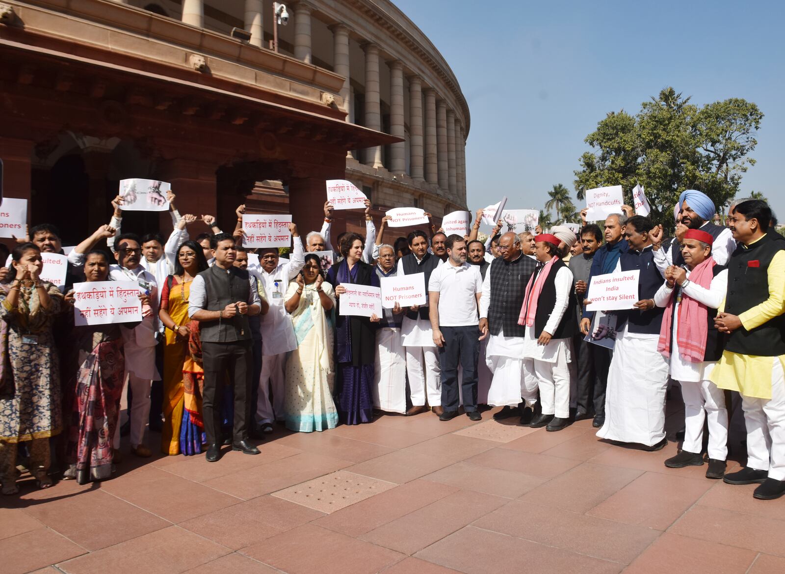 India's opposition lawmakers, some of them wearing shackles, stage a protest outside the Parliament in New Delhi, to condemn the reported mistreatment of Indian immigrants during their deportation from the United States, Thursday, Feb.6, 2025. The banners in Hindi language read "Indians in shackles, will not tolerate the insult." (AP Photo)