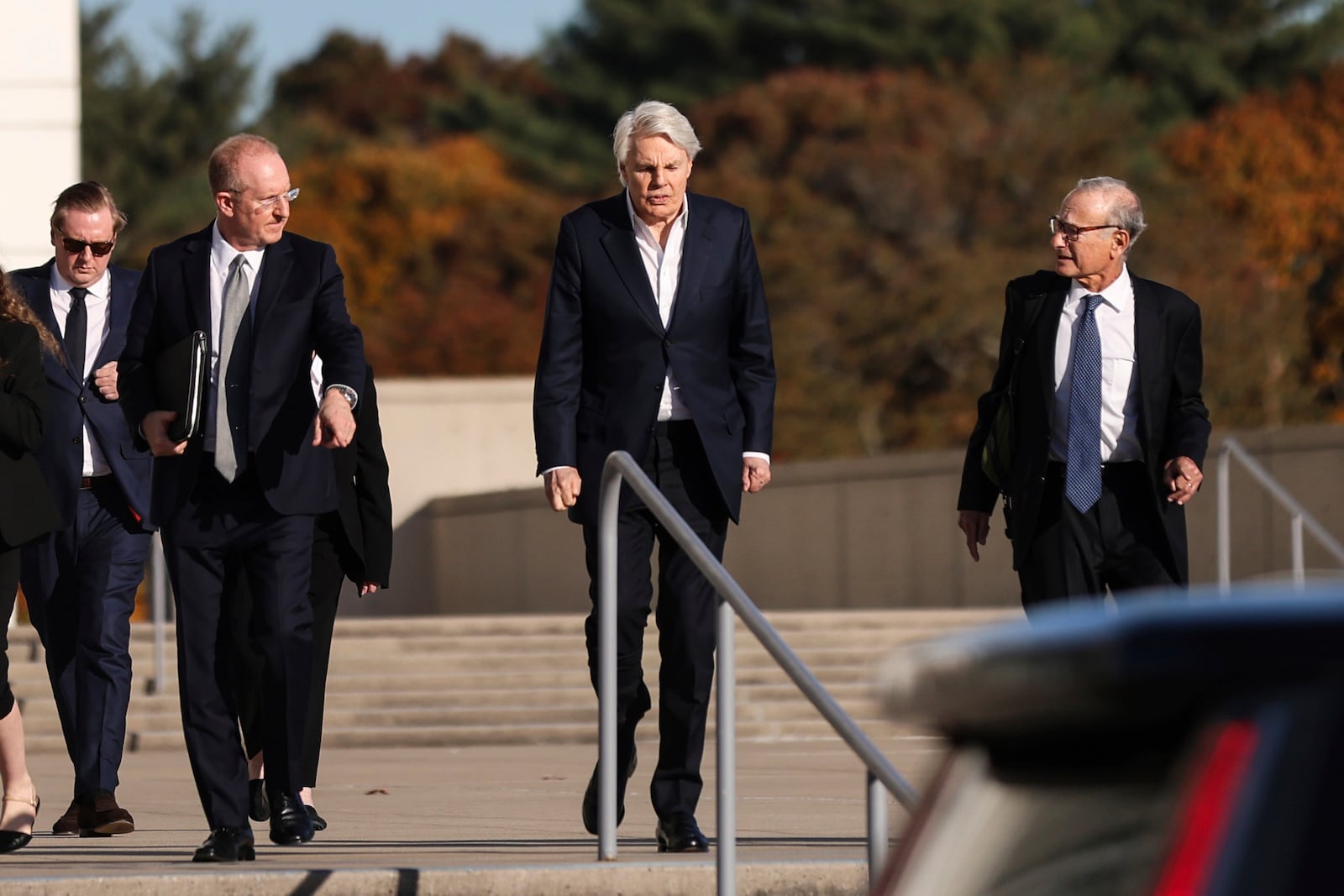 Michael Jeffries, center, former CEO of Abercrombie & Fitch, exits the federal courthouse after his arraignment on sex trafficking and interstate prostitution charges, Friday, Oct. 25, 2024, in Central Islip, N.Y. (AP Photo/Heather Khalifa)