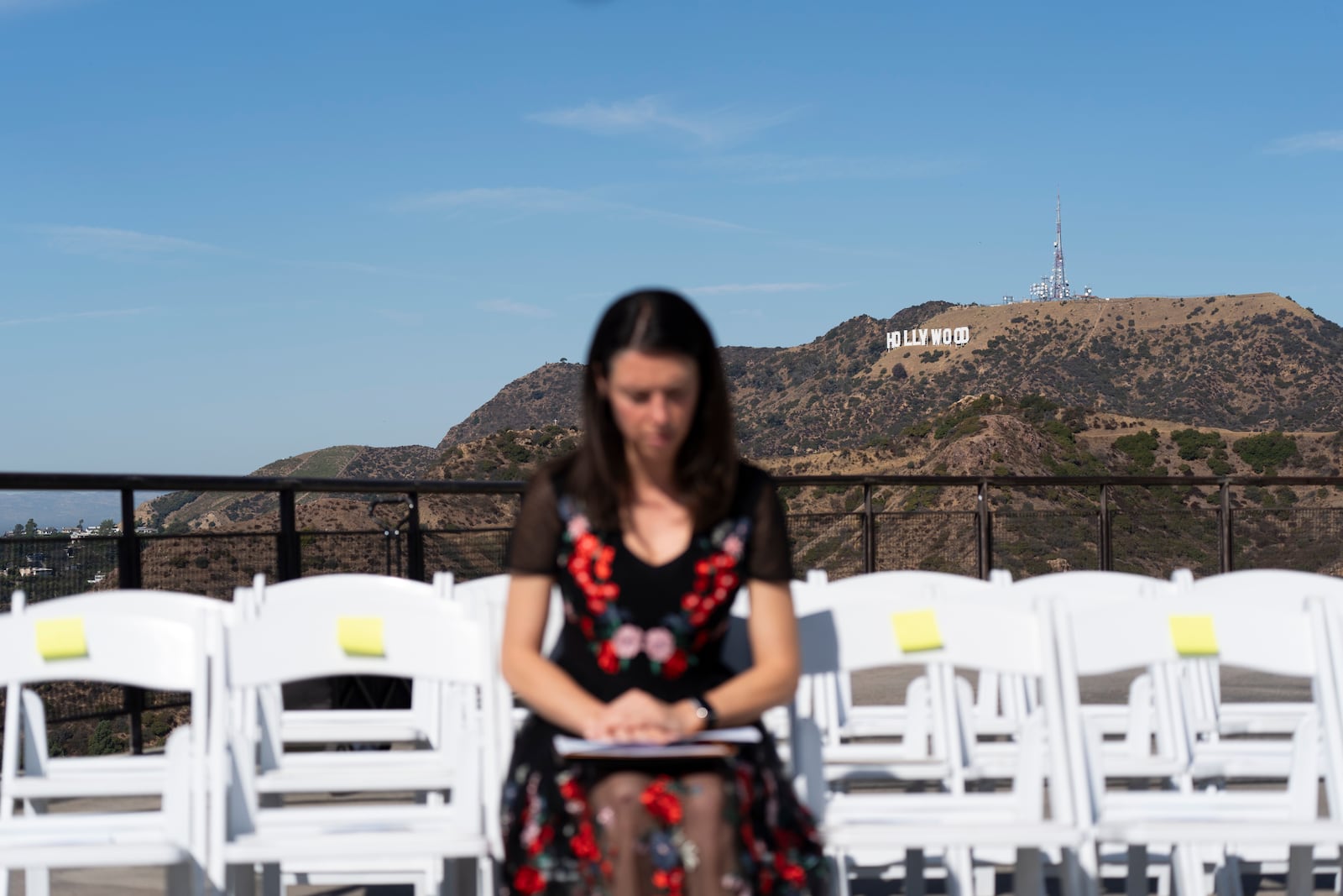 Floriane Turcat, a 37-year-old actress from France, waits for a naturalization ceremony to start at Griffith Observatory in Los Angeles, Monday, Oct. 21, 2024. (AP Photo/Jae C. Hong)