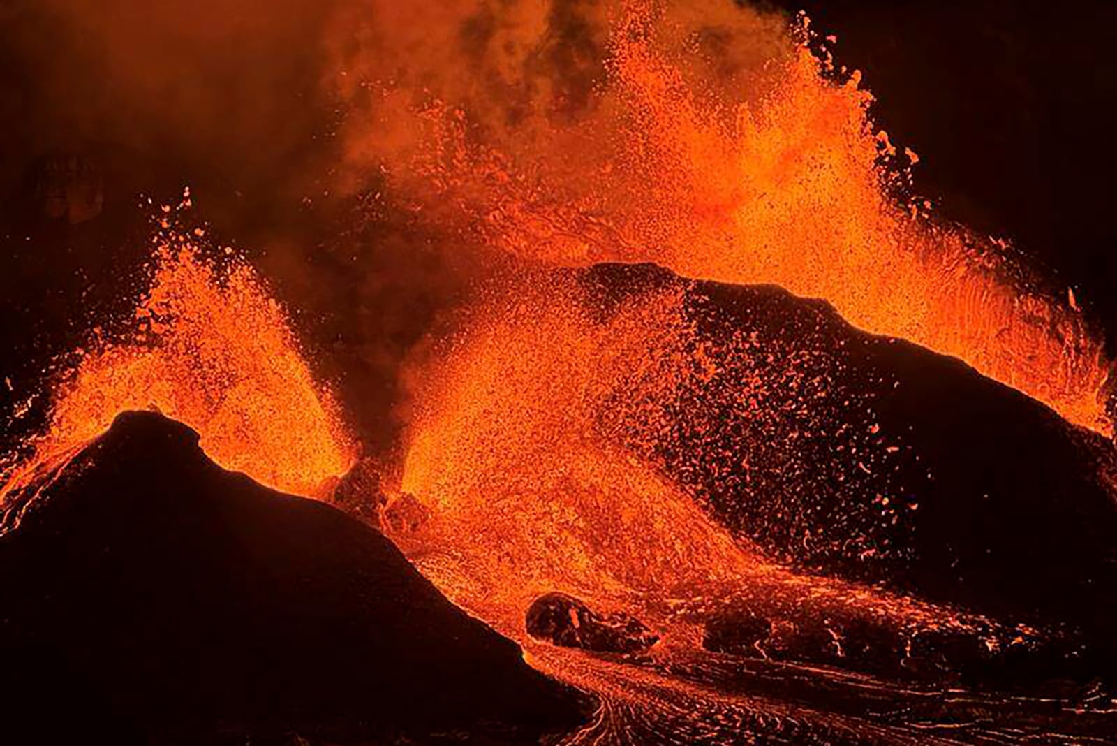 In this image provided the. the U.S. Geological Survey shows evening views of lava fountaining from Haleumaumau Crater at the summit of Kilauea volcano inside Hawaii Volcanoes National Park, Hawaii., on Tuesday, Feb. 11, 2025. (M. Patrick/U.S. Geological Survey via AP)