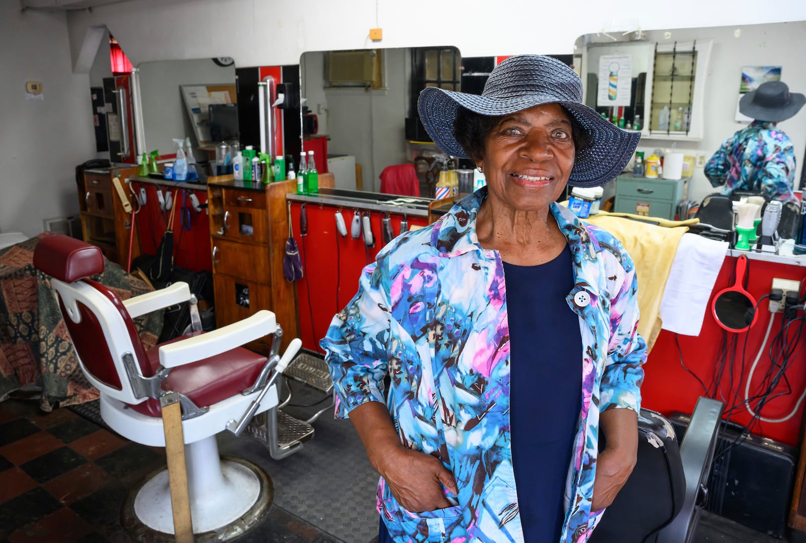 Courtney Speed, of Turner Station, Md., stands in Speed's Barber and Beauty, her salon, Sunday, Aug. 18, 2024, in Turner Station. Turner Station is located near the former site of the Francis Scott Key Bridge, which collapsed in March. (AP Photo/Steve Ruark)