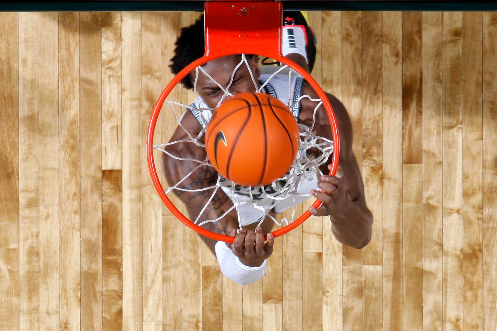 Michigan State forward Coen Carr throws down a reverse dunk during the first half of an NCAA college basketball game against Wisconsin, Sunday, March 2, 2025, in East Lansing, Mich. (AP Photo/Al Goldis)