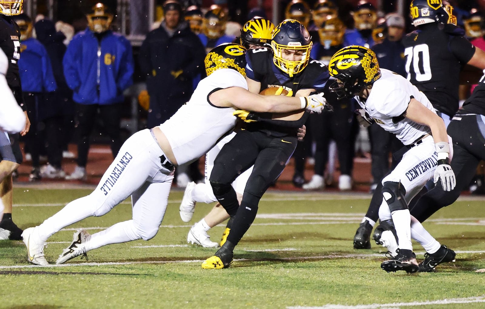 Centerville's Brady Seeley tackles Moeller's Deacon Simmons during their Division I state semifinal football game Friday, Nov. 29, 2024 at Princeton High School in Sharonville. Moeller won 49-10 to advance. NICK GRAHAM/STAFF