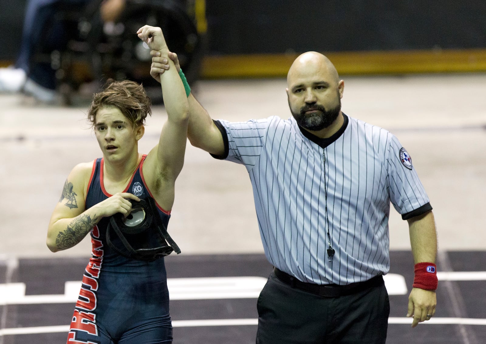 FILE - A referee raises the arm of Mack Beggs of Euless Trinity after he defeated Chelsea Sanchez of Morton Ranch to defend the Class 6A girls 110-pound title during the UIL State Wrestling Championships at the Berry Center in Cypress, Texas, on Saturday, Feb. 24, 2018. Texas limits transgender athletes to teams conforming with the gender on their birth certificate. That law came under criticism in 2017 and 2018, when transgender male Beggs won state titles in girls' wrestling competitions after he was told he could not compete as a boy. (Jason Fochtman/Houston Chronicle via AP)