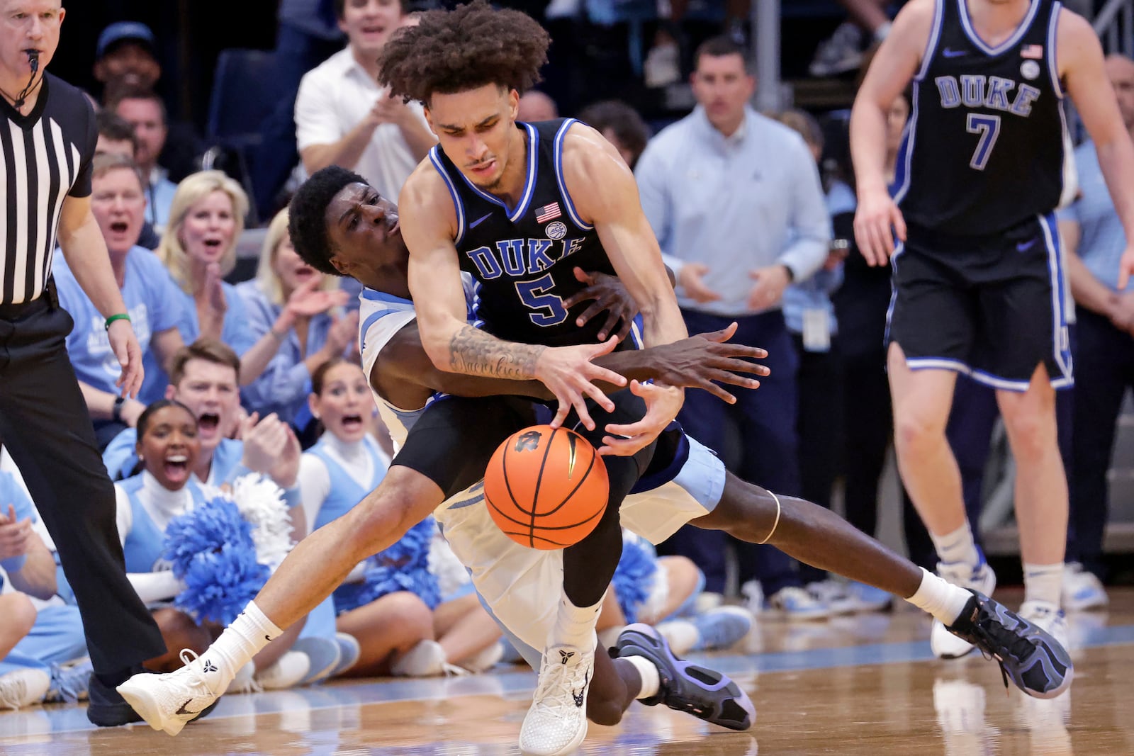 North Carolina guard Drake Powell, left, tries to take the ball from Duke guard Tyrese Proctor (5) during the first half of an NCAA college basketball game Saturday, March 8, 2025, in Chapel Hill, N.C. (AP Photo/Chris Seward)