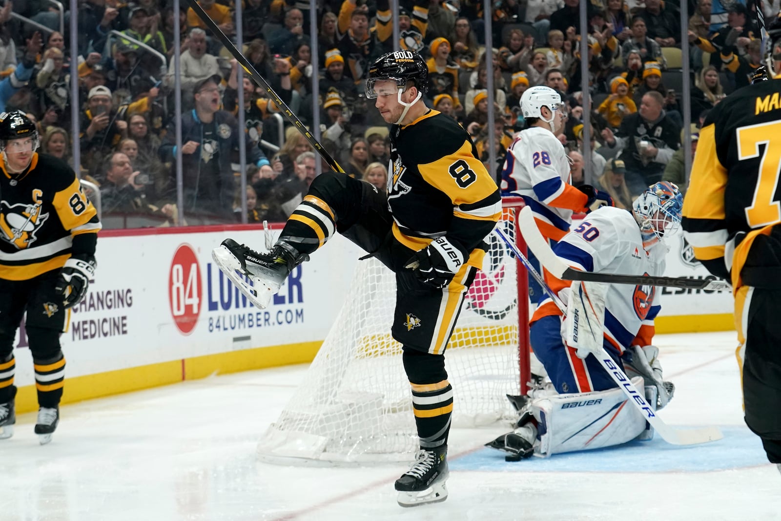 Pittsburgh Penguins' Michael Bunting (8) celebrates after scoring during the second period of an NHL hockey game against the New York Islanders, Sunday, Dec. 29, 2024, in Pittsburgh. (AP Photo/Matt Freed)