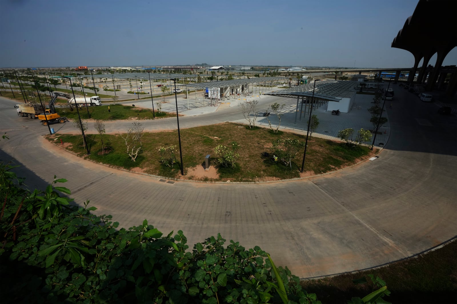 An overview from beside of parking in front an under construction of a new airport of Techo International Airport at the outskirts of Phnom Penh Cambodia, Friday, March 21, 2025. (AP Photo/Heng Sinith)