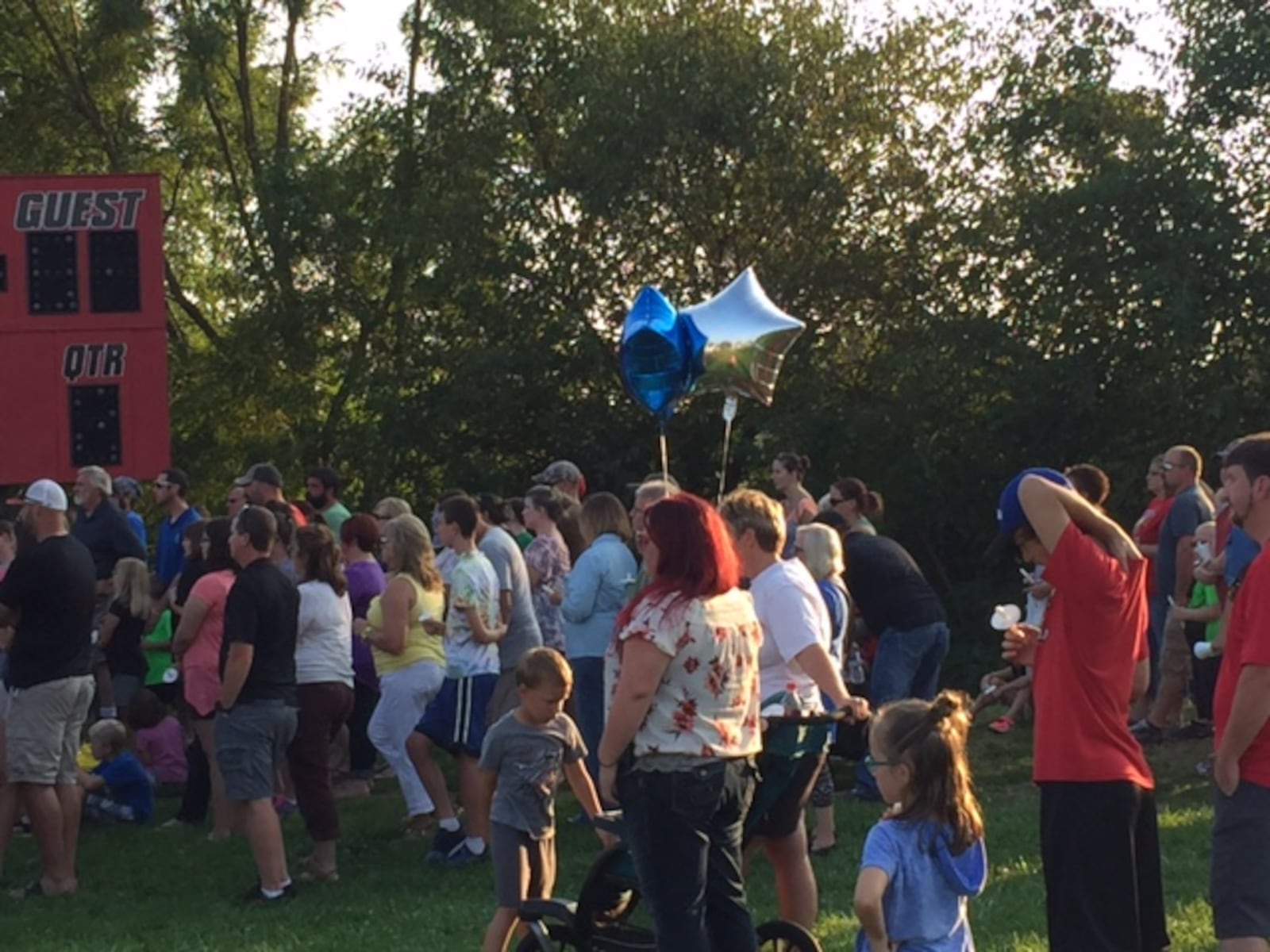 Community members gather at Camden Primary School's football field Sunday for a candlelight vigil honoring a family of three killed in a Tuesday crash on Ohio 127 at Ohio 725. Sean Cudahy/Staff