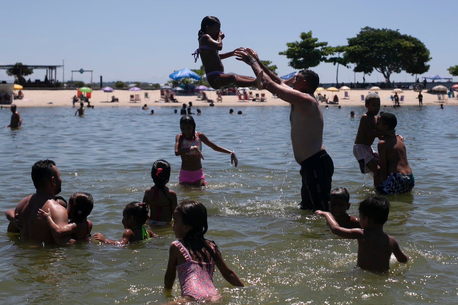 People relax at the Piscinao de Ramos artificial beach during summer in Rio de Janeiro, Sunday, Feb. 16, 2025. (AP Photo/Bruna Prado)