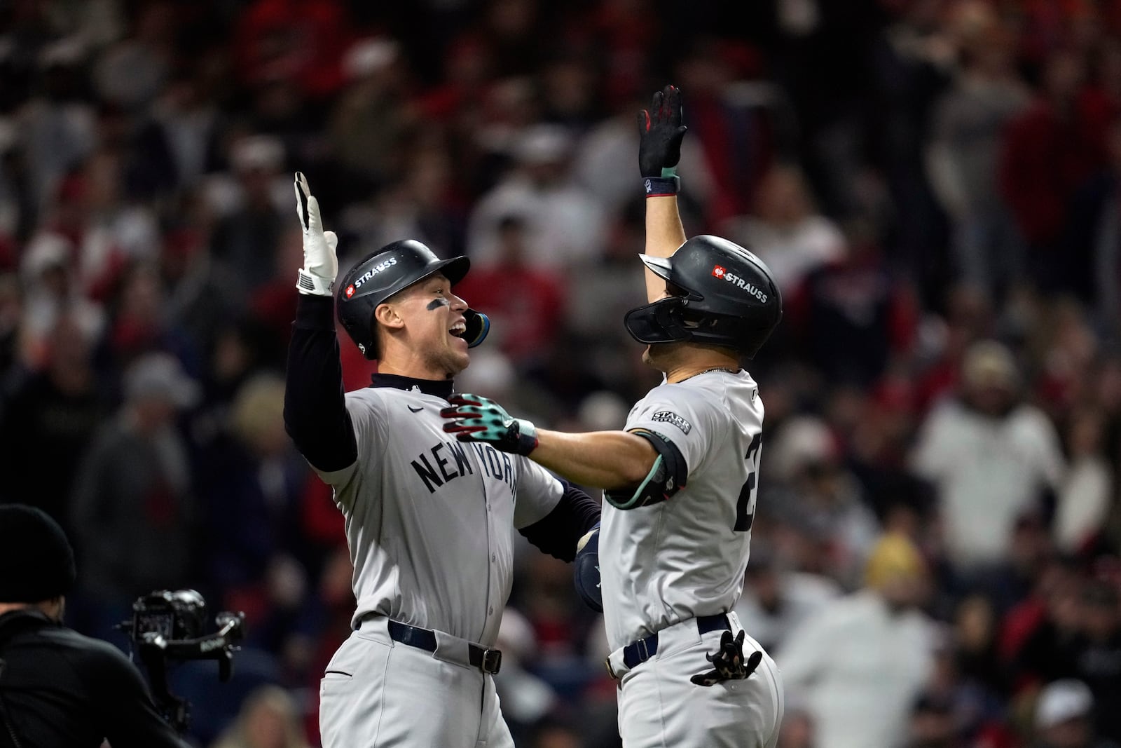 New York Yankees' Giancarlo Stanton, right, celebrates with Aaron Judge after hitting three-run home run against the Cleveland Guardians during the sixth inning in Game 4 of the baseball AL Championship Series Friday, Oct. 18, 2024, in Cleveland. (AP Photo/Godofredo A. Vásquez)