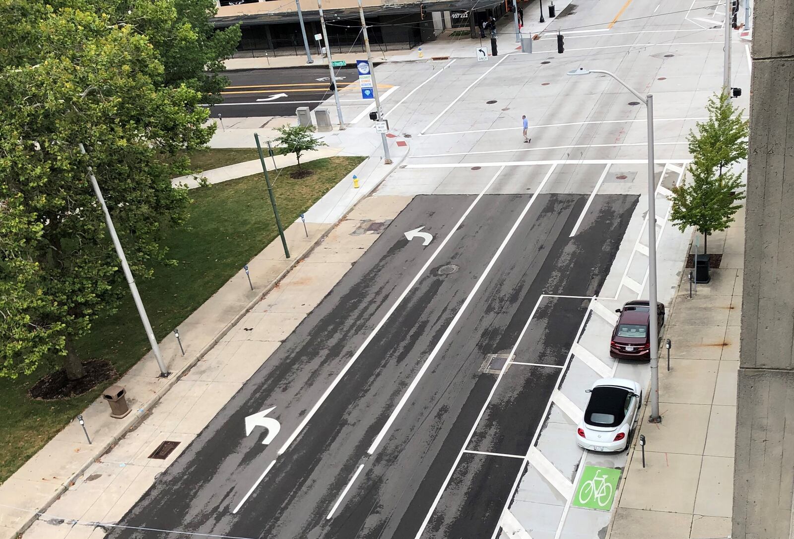 Two cars block a protected bike lane on Jefferson Street on Monday. CORNELIUS FROLIK / STAFF