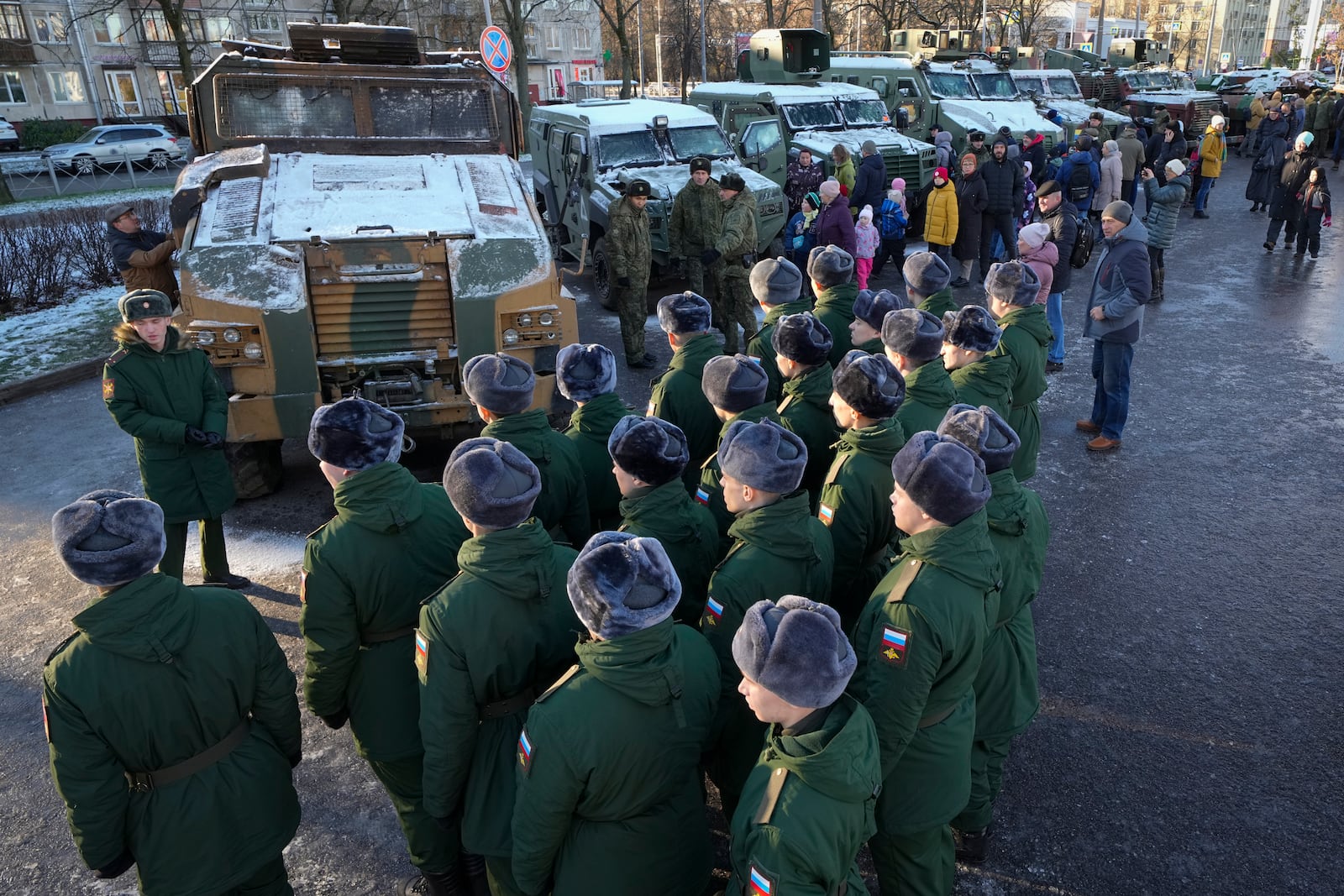 Russian servicemen examine Ukrainian military vehicles at an exhibition featuring military equipment captured from Kyiv forces during the fighting in Ukraine, during Russia's National Unity Day in St. Petersburg, Russia, Monday, Nov. 4, 2024. (AP Photo/Dmitri Lovetsky)