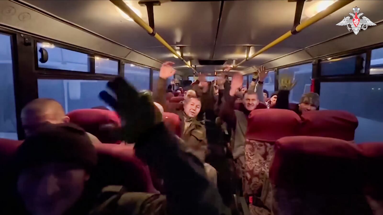 In this photo taken from video released by the Russian Defense Ministry Press Service on Monday, Dec. 30, 2024, a group of Russian soldiers sit in a bus after being released in a prisoners swap between Russia and Ukraine, at an unspecified location in Belarus. (Russian Defense Ministry Press Service via AP)