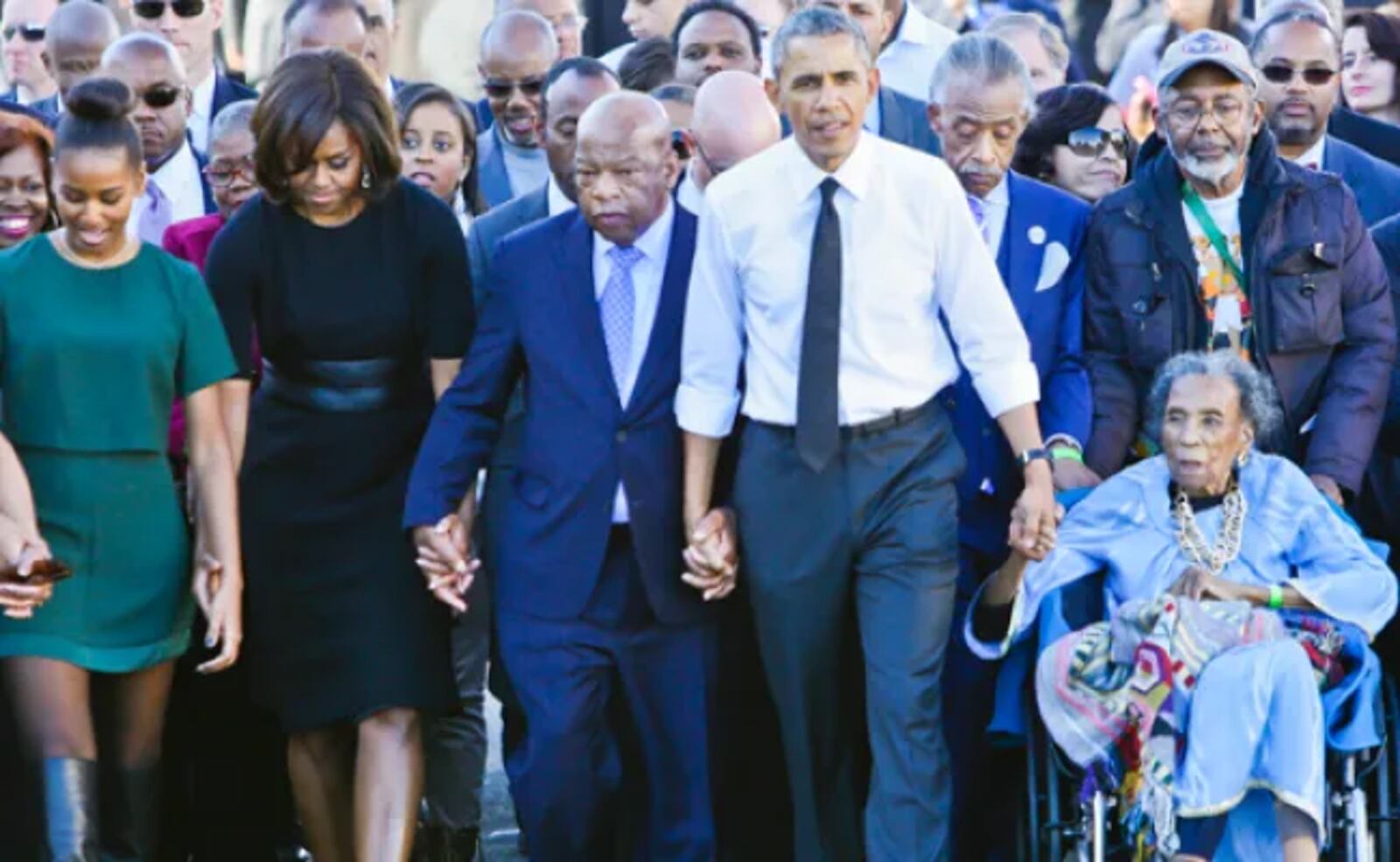 Leon Frazier, at far right, a former Dayton police officer and chief of Central State University and the former Jefferson Twp. Police departments, pushes the wheelchair for Amelia Boynton Robinson, a civil rights activist, on the 50th anniversary of the Bloody Sunday march in Selma, Alabama. CONTRIBUTED