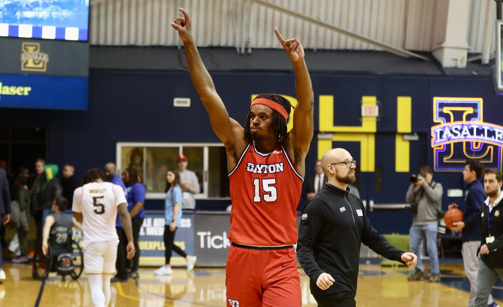 Dayton's DaRon Holmes II salutes the crowd after a victory against La Salle on Tuesday, Jan. 23, 2024, at Tom Gola Arena in Philadelphia. David Jablonski/Staff