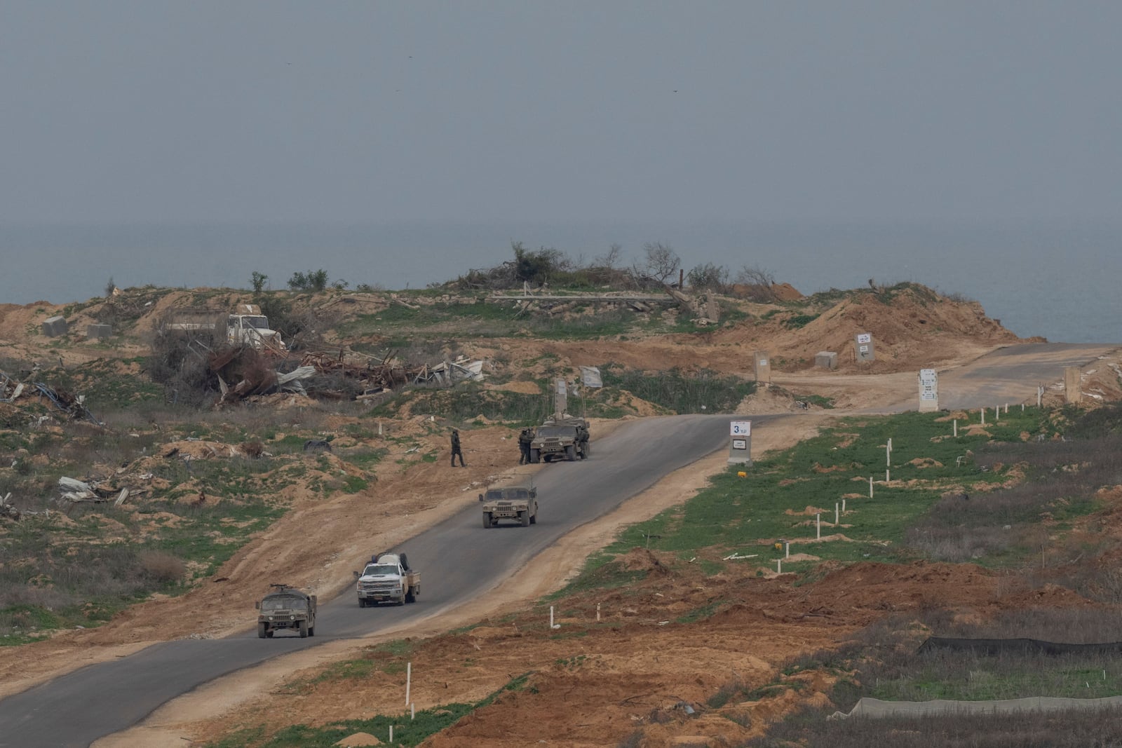 Israeli soldiers inside the northern Gaza Strip as seen from southern Israel, Sunday, Feb. 9, 2025. (AP Photo/Ohad Zwigenberg)