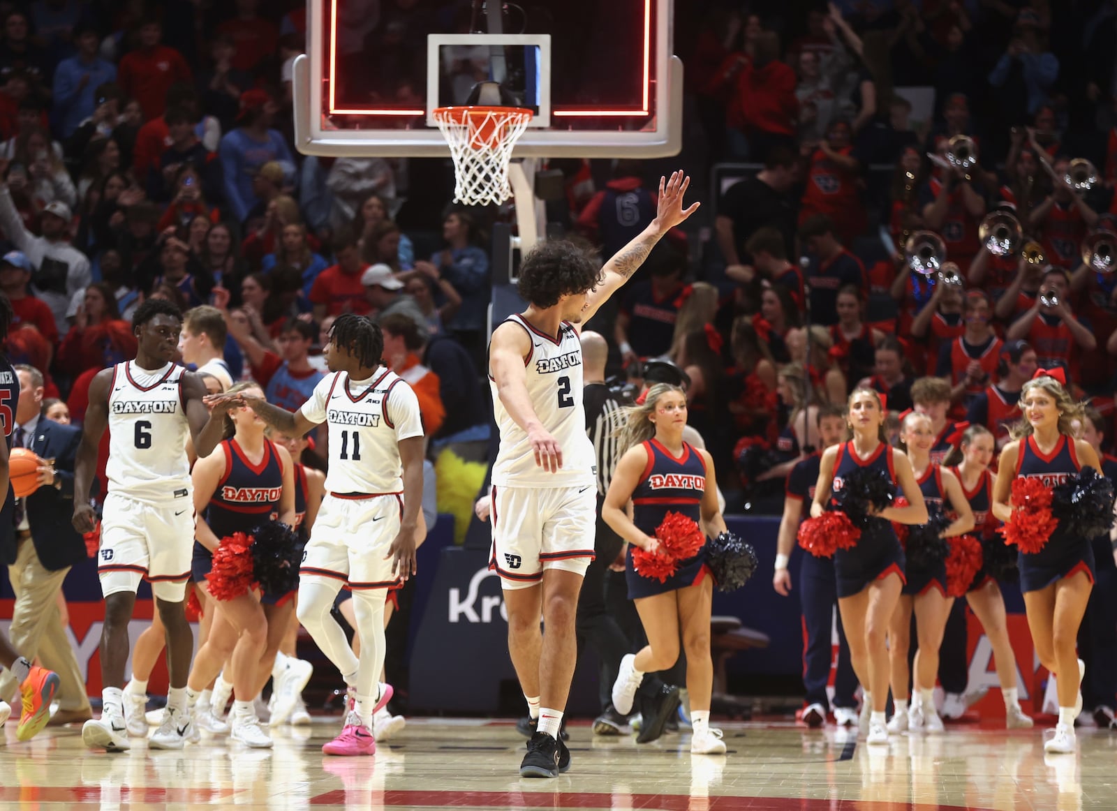 Dayton's Nate Santos waves to his family in the stands after a victory against Richmond on Saturday, March 1 2025, at UD Arena. David Jablonski/Staff