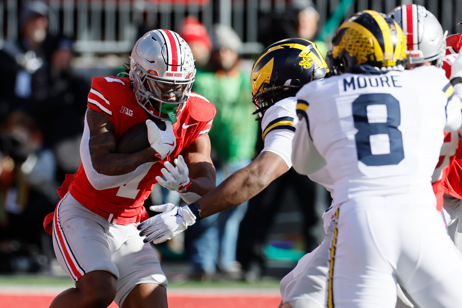 Ohio State running back Quinshon Judkins, left, runs the ball against Michigan during the first half of an NCAA college football game Saturday, Nov. 30, 2024, in Columbus, Ohio. (AP Photo/Jay LaPrete)