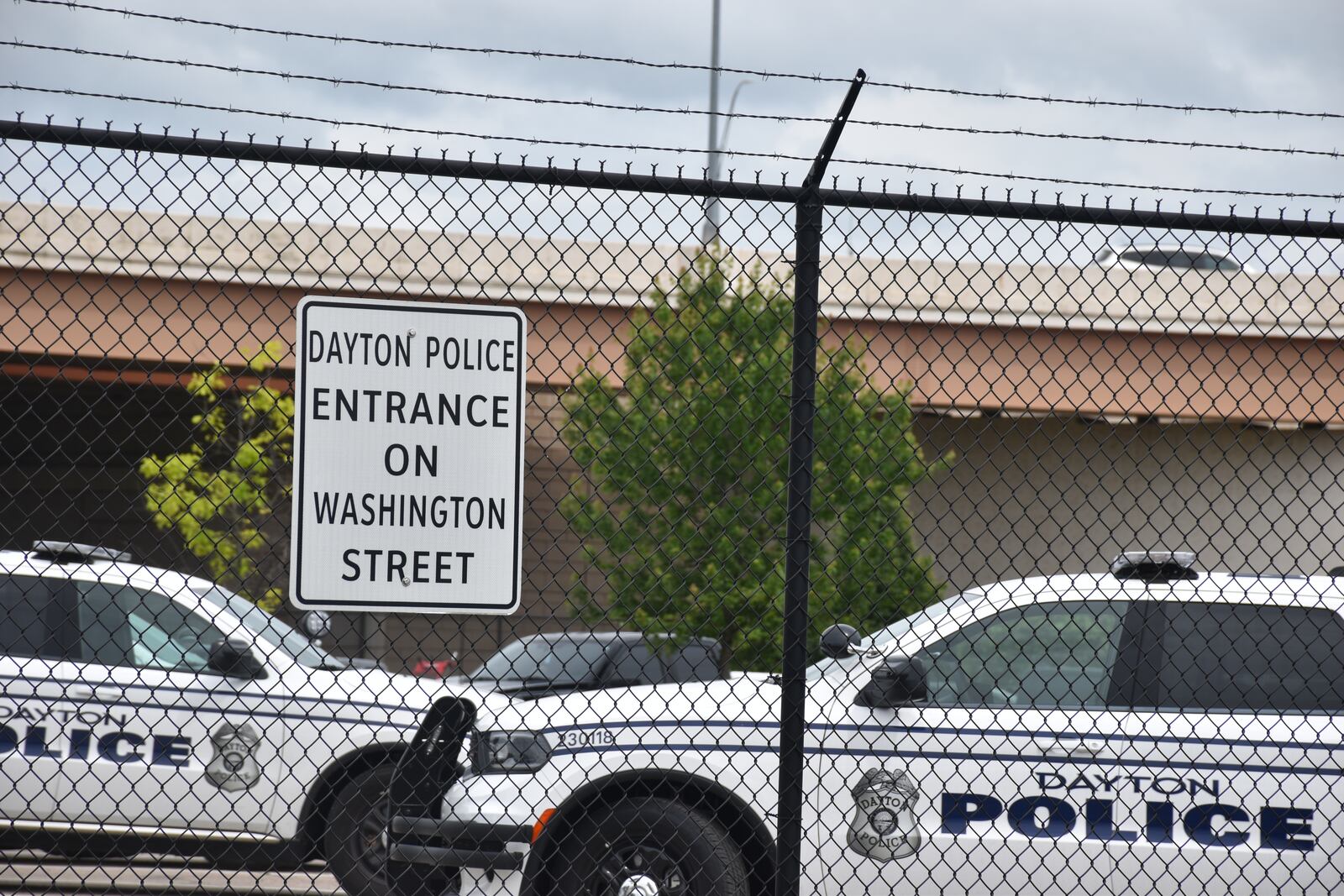 A secured parking lot at the Dayton Police Department's west patrol district on Helena Street in West Dayton. CORNELIUS FROLIK / STAFF