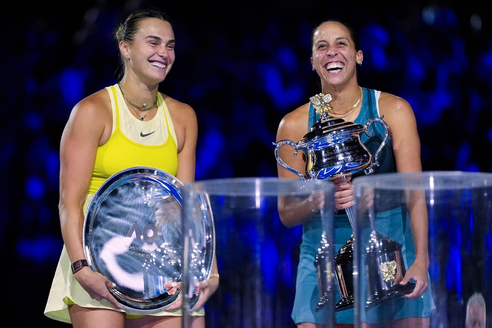 Madison Keys, right, of the U.S. reacts as she holds the Daphne Akhurst Memorial Cup after defeating Aryna Sabalenka, left, of Belarus in the women's singles final at the Australian Open tennis championship in Melbourne, Australia, Saturday, Jan. 25, 2025. (AP Photo/Asanka Brendon Ratnayake)