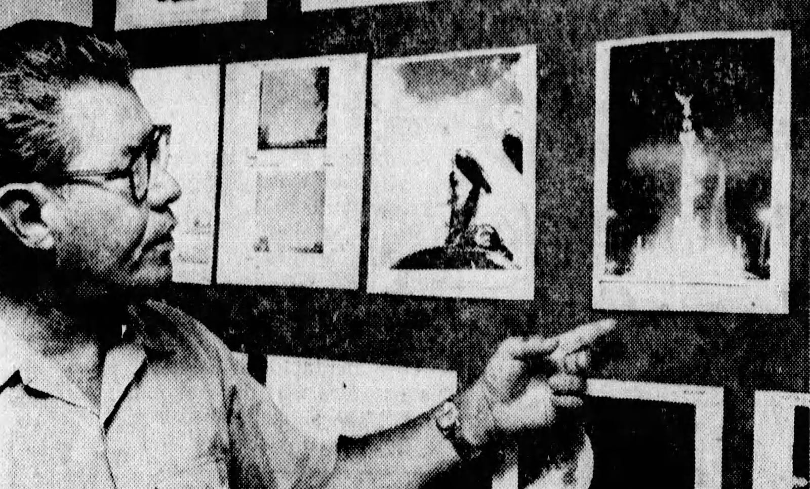 Lt. Col. Hector Quintanella looks at photos of so-called UFOs displayed in the Project Blue Book office at Wright-Patterson Air Force Base in 1968. DAYTON DAILY NEWS ARCHIVES