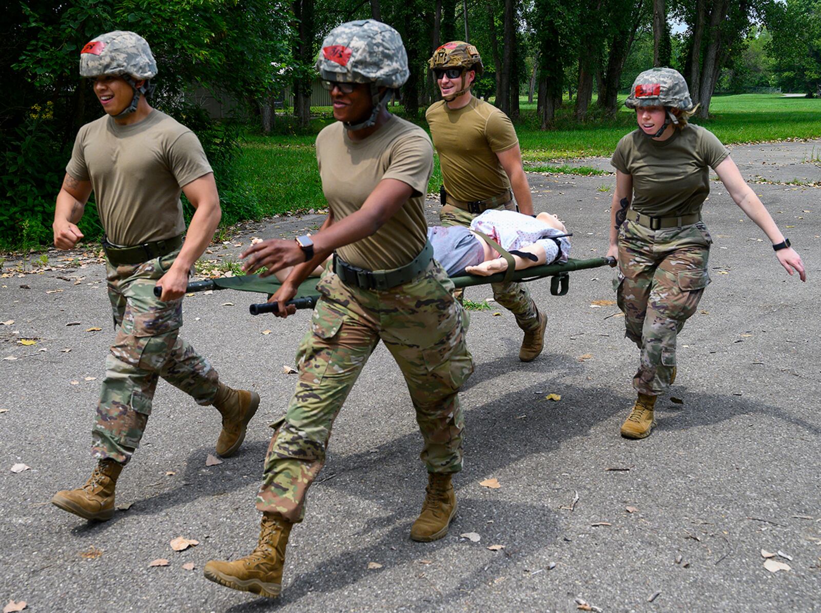 From left: Senior Airman Ivan Tendenilla, 88th Comptroller Squadron; 1st Lt. Juawana Stringer, 88th Medical Group; Airman 1st Class Andrew Ertmer, of the 788th Civil Engineer Squadron’s Explosive Ordnance Disposal Flight; and Senior Airman Kristin Betsch, 88th Medical Group, practice carrying a “patient” on a litter during buddy care training Aug. 11 at the Warfighter Training Center. U.S. AIR FORCE PHOTO/R.J. ORIEZ