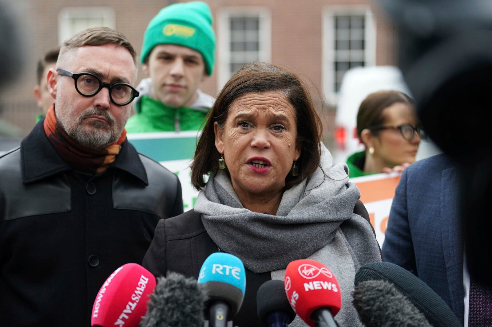 Sinn Fein leader Mary Lou McDonald, center, speaks to the media outside Government Buildings, on the last day of campaigning on the eve of the General Election, in Dublin, Thursday, Nov. 28, 2024. (Brian Lawless/PA via AP)