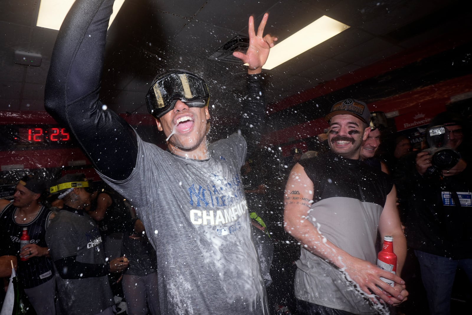 New York Yankees' Juan Soto, left, and Austin Wells celebrate in the clubhouse after Game 5 of the baseball AL Championship Series against the Cleveland Guardians Sunday, Oct. 20, 2024, in Cleveland. The Yankees won 5-2 to advance to the World Series. (AP Photo/Godofredo A. Vásquez )