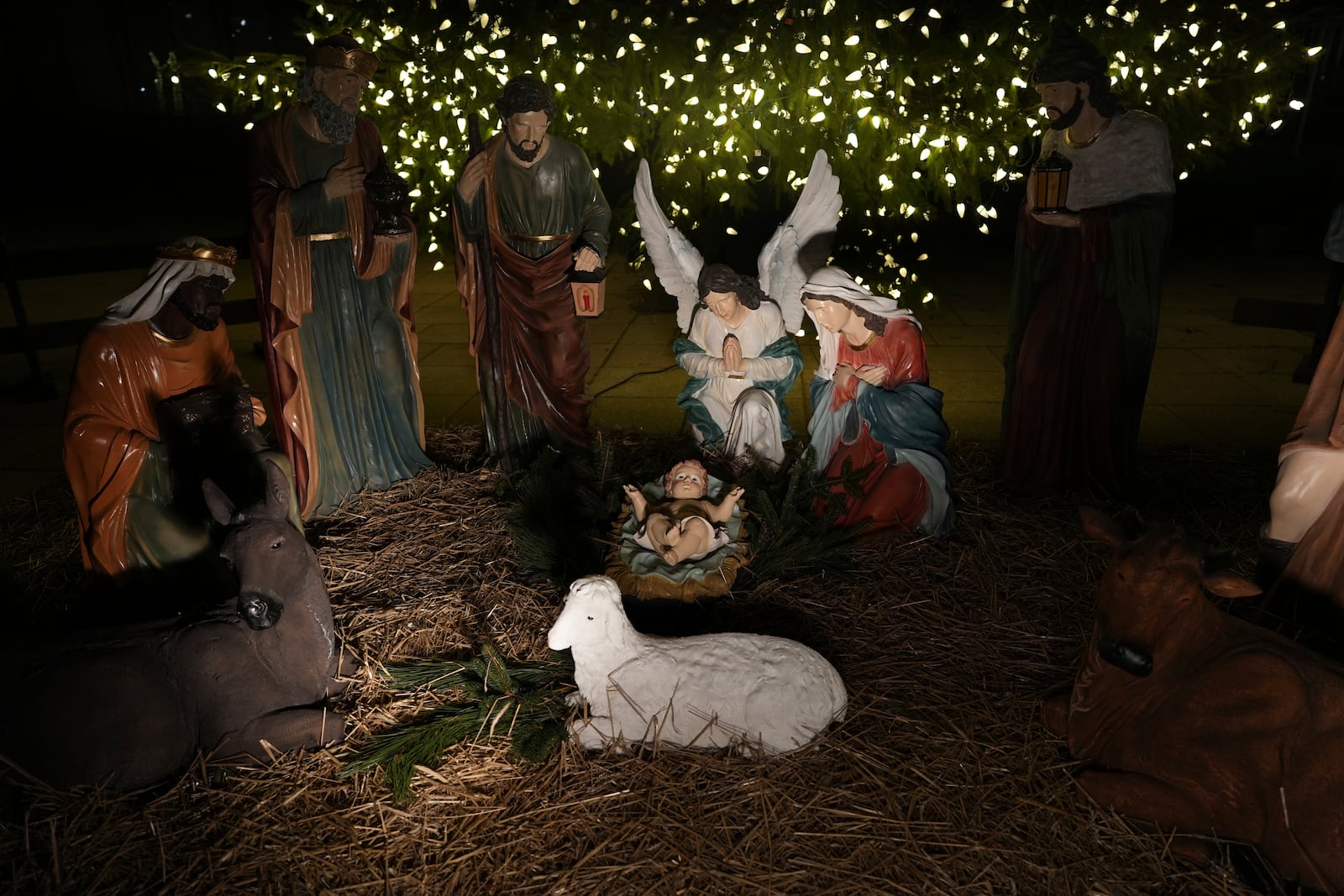 A Nativity scene is illuminated by a Christmas tree on Payrow Plaza in Bethlehem, Pa., known as “Christmas City, USA,” on Sunday, Dec. 1, 2024. (AP Photo/Luis Andres Henao)