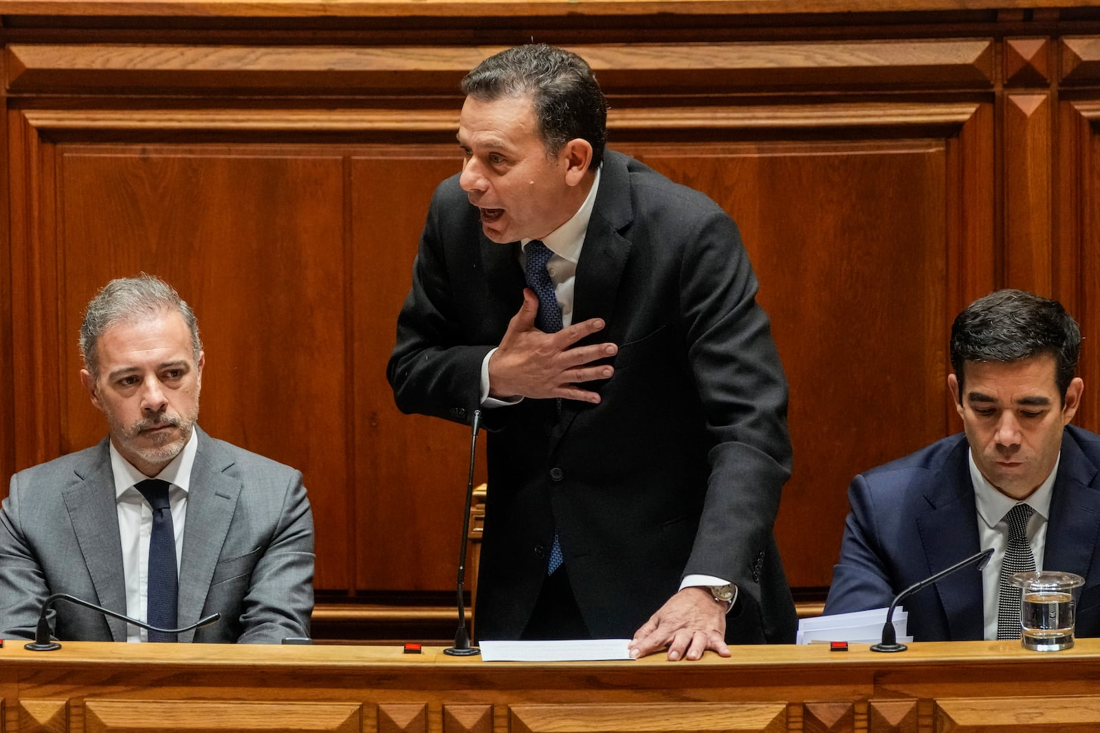 Portuguese Prime Minister Luis Montenegro, center, talks during a debate preceding a confidence motion vote at the Portuguese parliament in Lisbon, Tuesday, March 11, 2025. (AP Photo/Armando Franca)