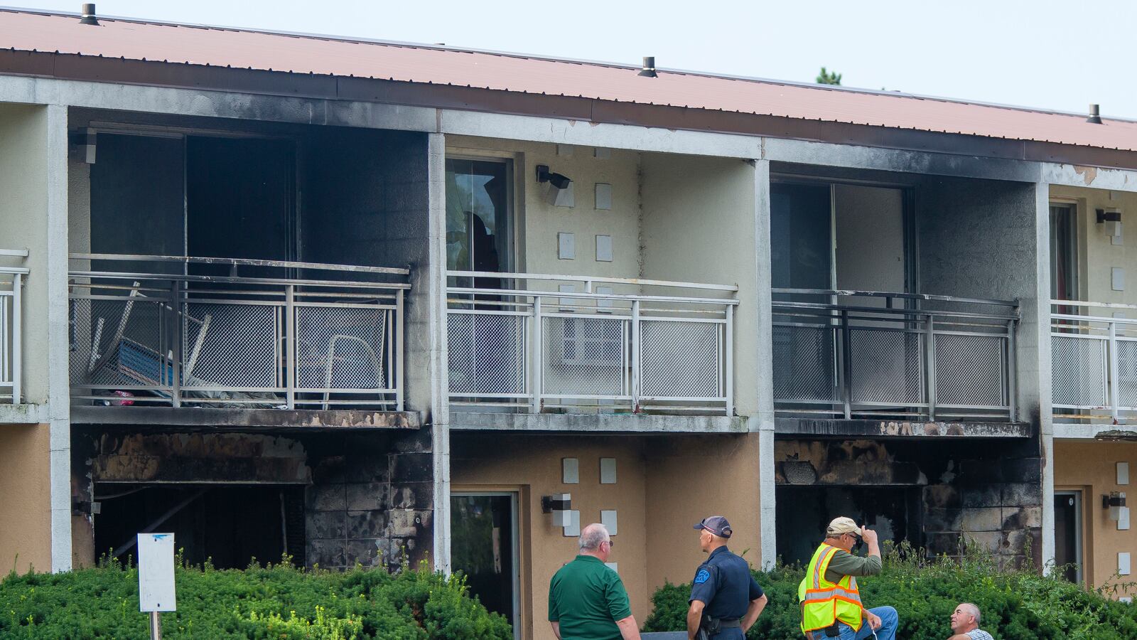 Officials investigate at a fire at the Cosmo Extended Stay Motel in Sodus Township, Mich., on Saturday, July 28, 2018.  Several members of the same family, including a woman and her five children, were killed, authorities said.