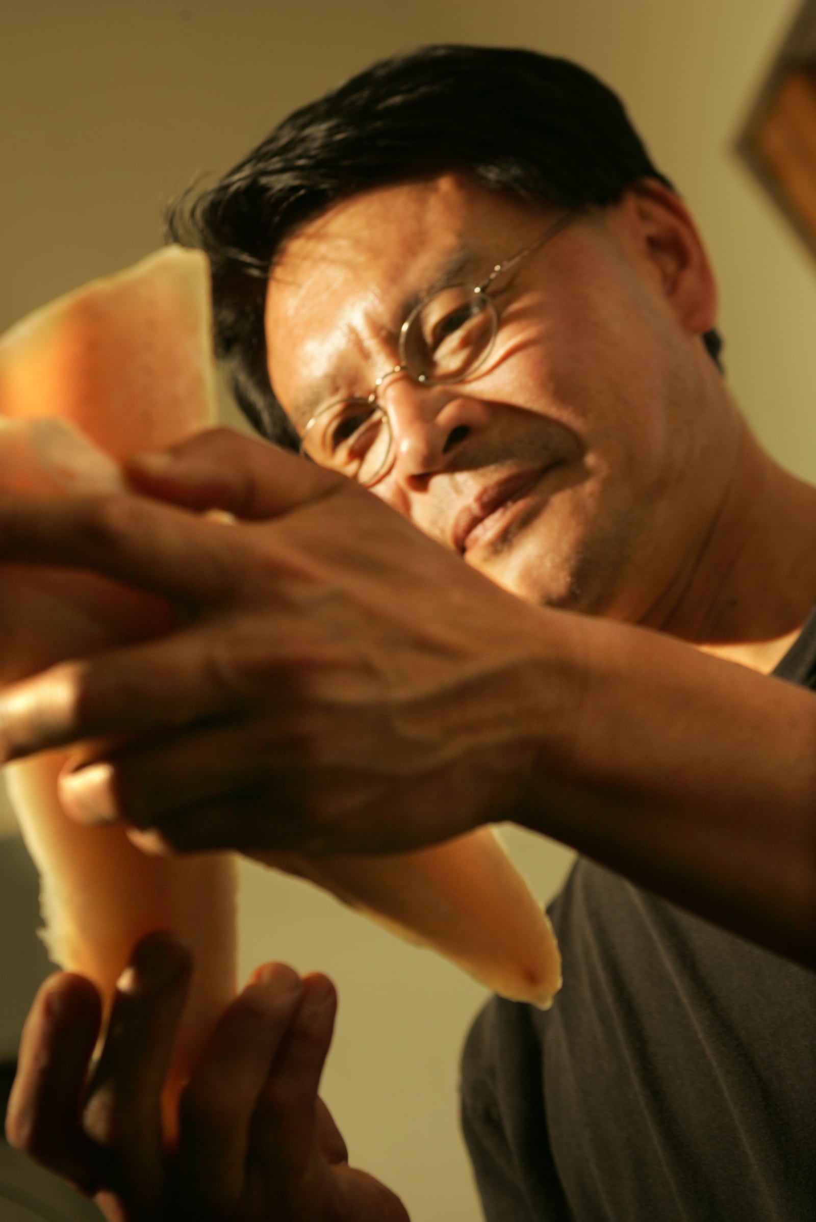 Art Chin, owner of Chin's Ginger Grill, 965 West Main Street in Tipp City, inspects frozen walleye filets from Midwest Seafood. The recent closing of Midwest has had a significant impact on local restaurants like Chin's who purchased nearly all their seafood items from the Springboro wholesaler. ARCHIVE PHOTO BY JIM WITMER