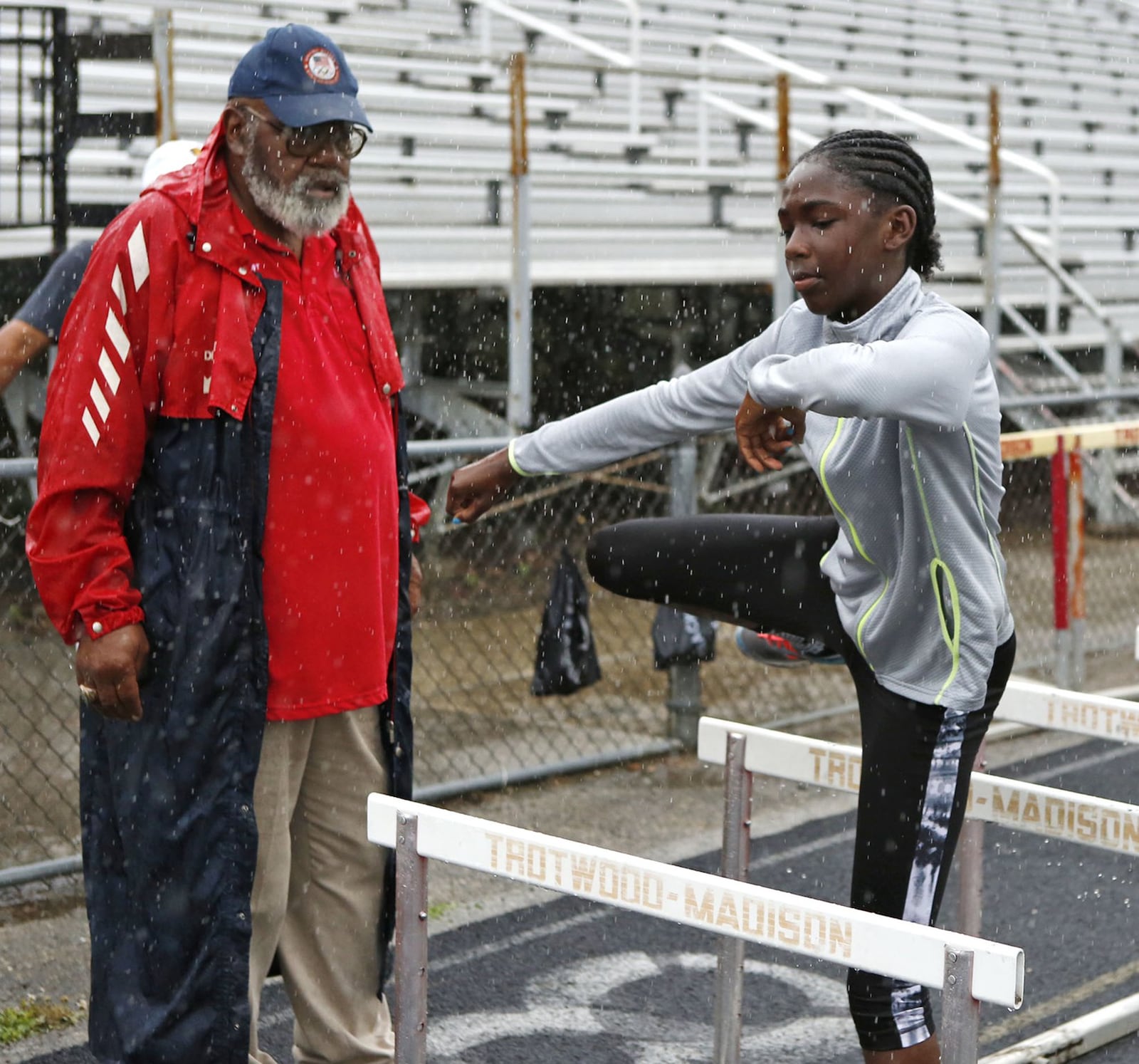 Harold “Lefty” Martin works with hurdler Camryn Nadi at the Trotwood track in 2015. DDN FILE