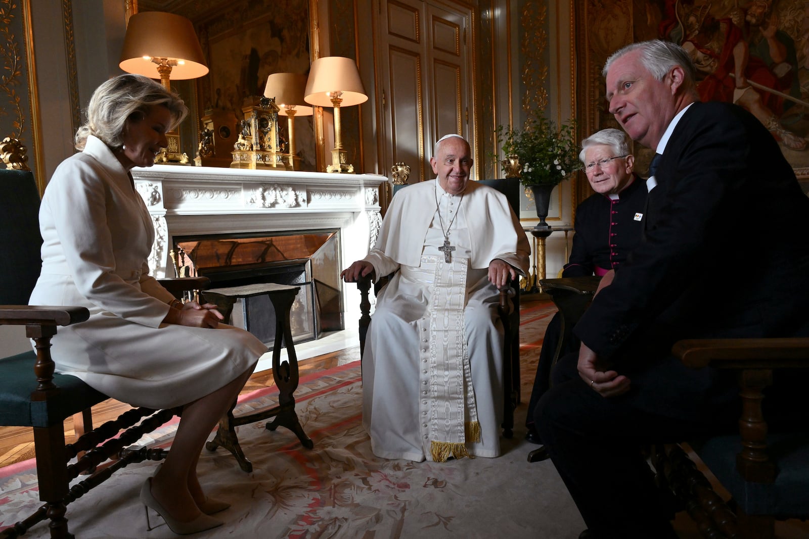 Pope Francis, center, talks to King Philippe of Belgium, right, and Queen Mathilde at the Castle of Laeken, Belgium, Friday, Sept. 26, 2024, on the second day of a four-day apostolic journey to Luxembourg and Belgium. (Alberto Pizzoli/pool photo via AP)