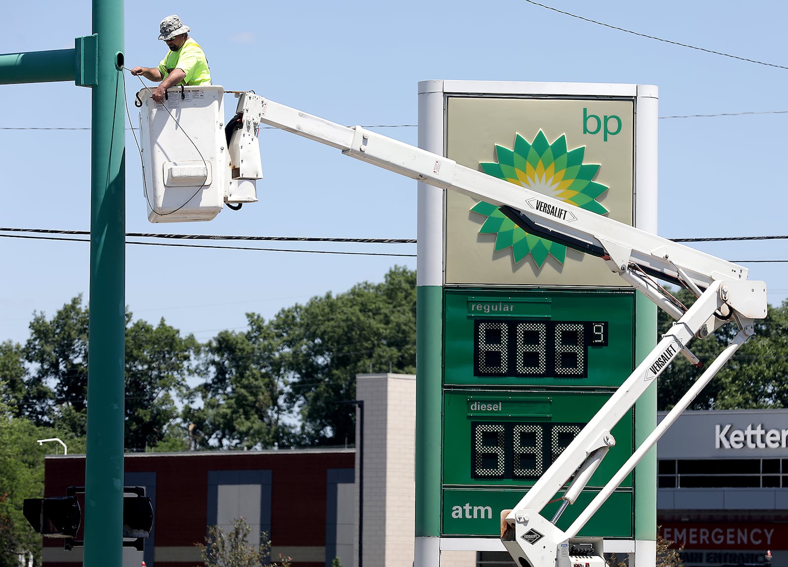 A City of Springfield employee works on a traffic signal at the intersection of Home Road and North Limestone Street. In the background a gas station sign advertises gas for $4.85 Monday, June 27, 2022. BILL LACKEY/STAFF