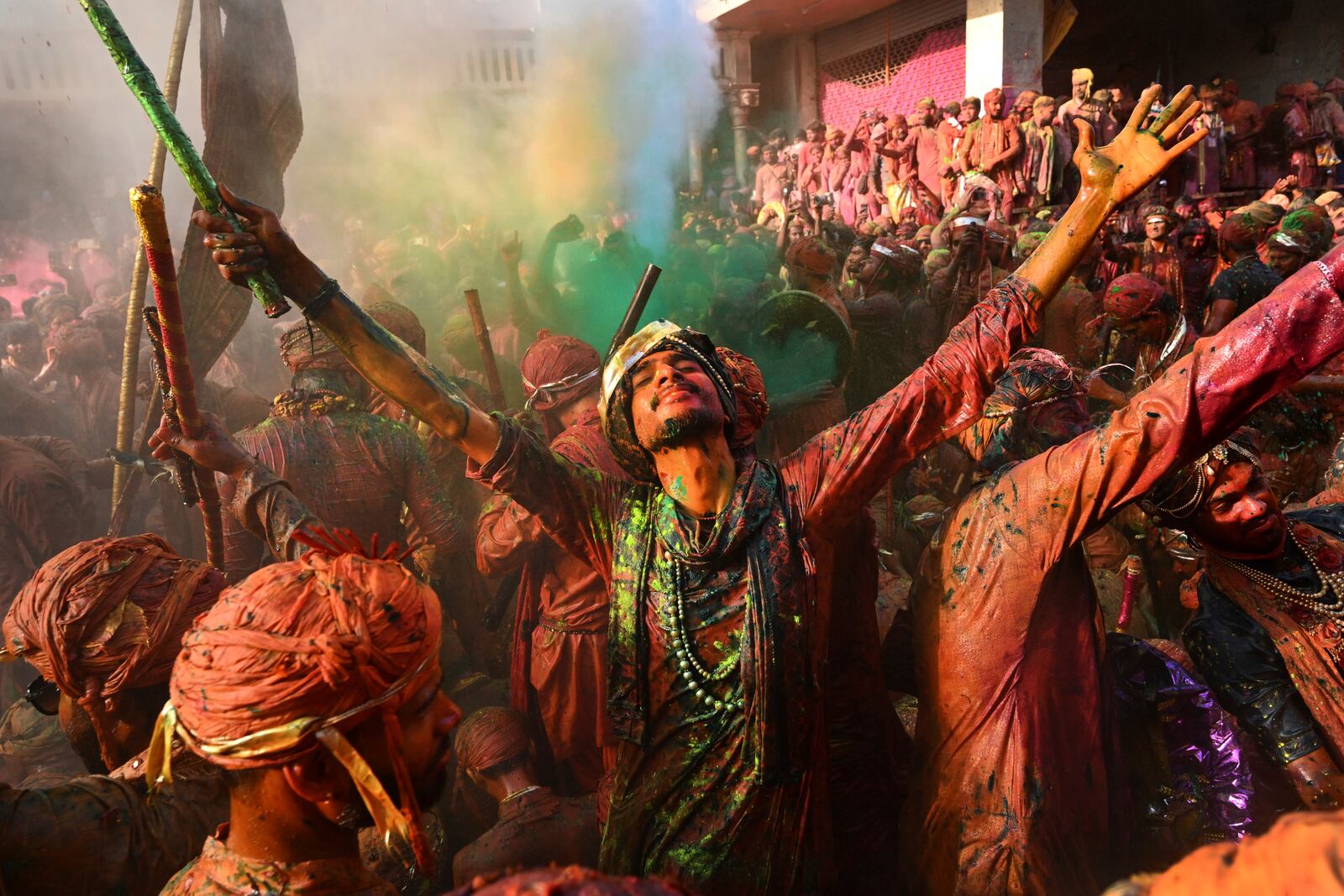 Villagers from Barsana and Nandgaon smeared with colors sing and dance as they participate Lathmar Holi at Nandagram temple in Nandgoan village, 115 kilometers (70 miles) south of New Delhi, India, Sunday March 9, 2025. (AP Photo)